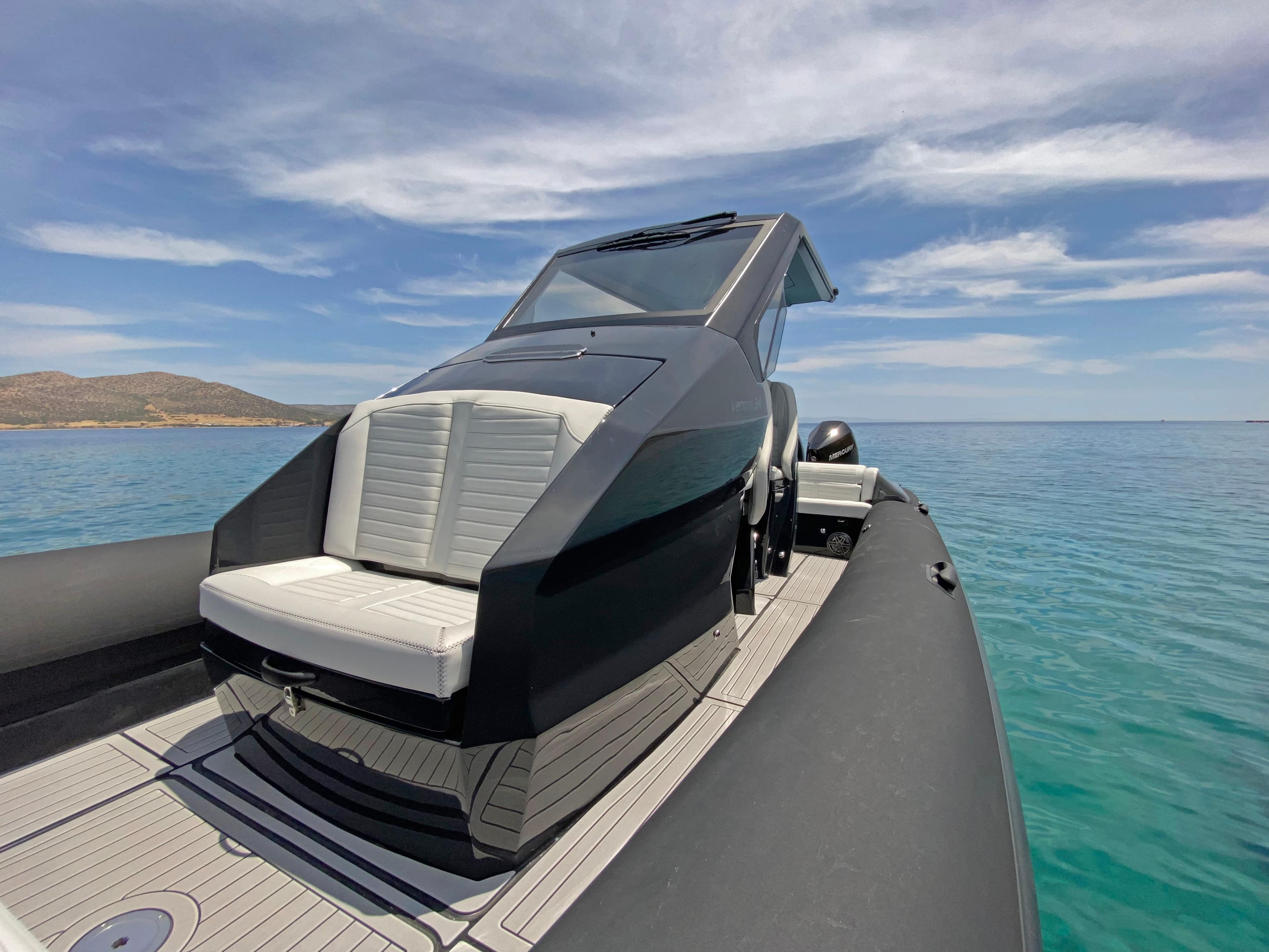 2024 Ribco Venom 34 boat on clear blue water under a partly cloudy sky.