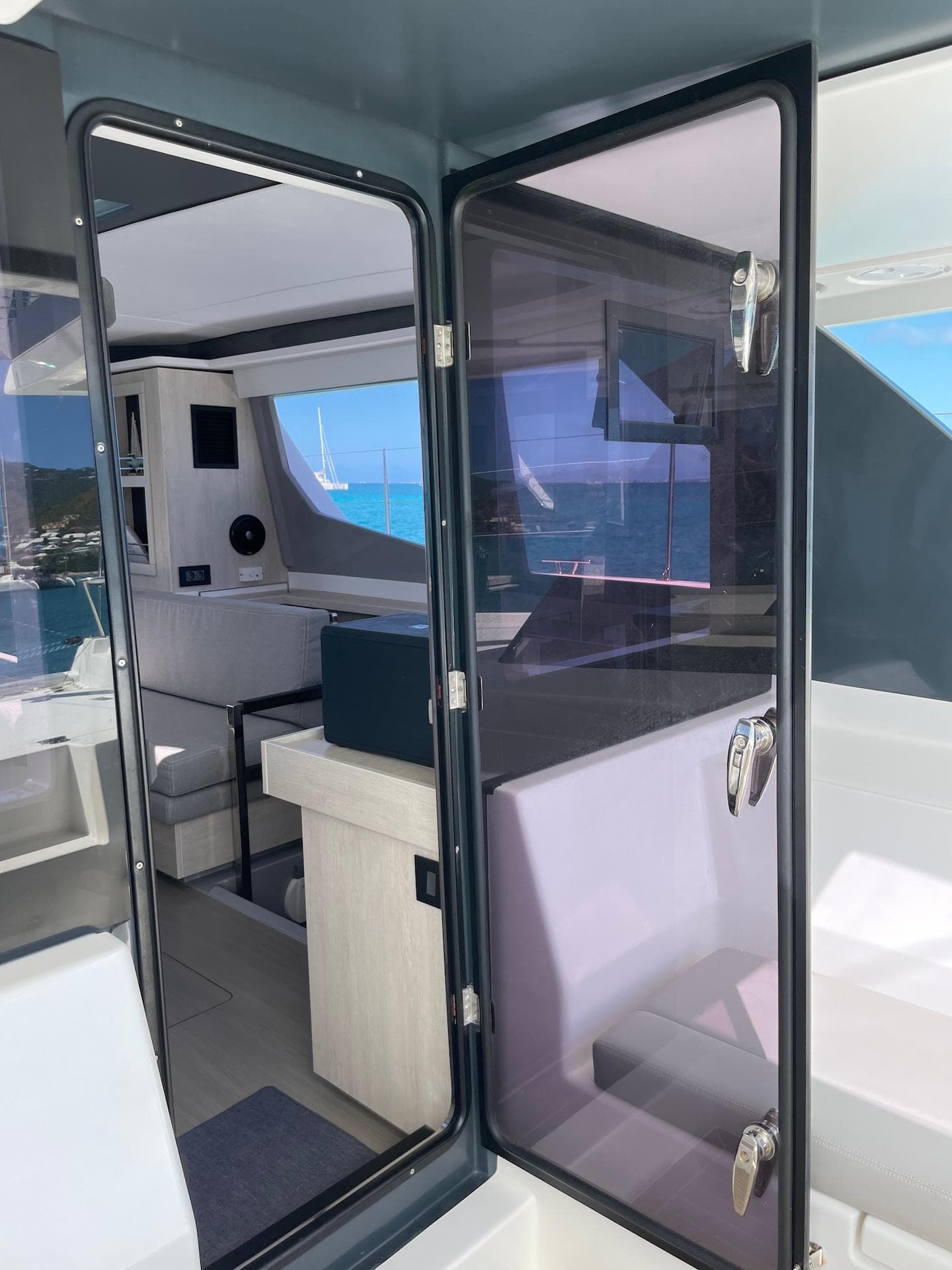 Interior view of a 2021 Leopard 45 catamaran, showcasing modern design and ocean backdrop.