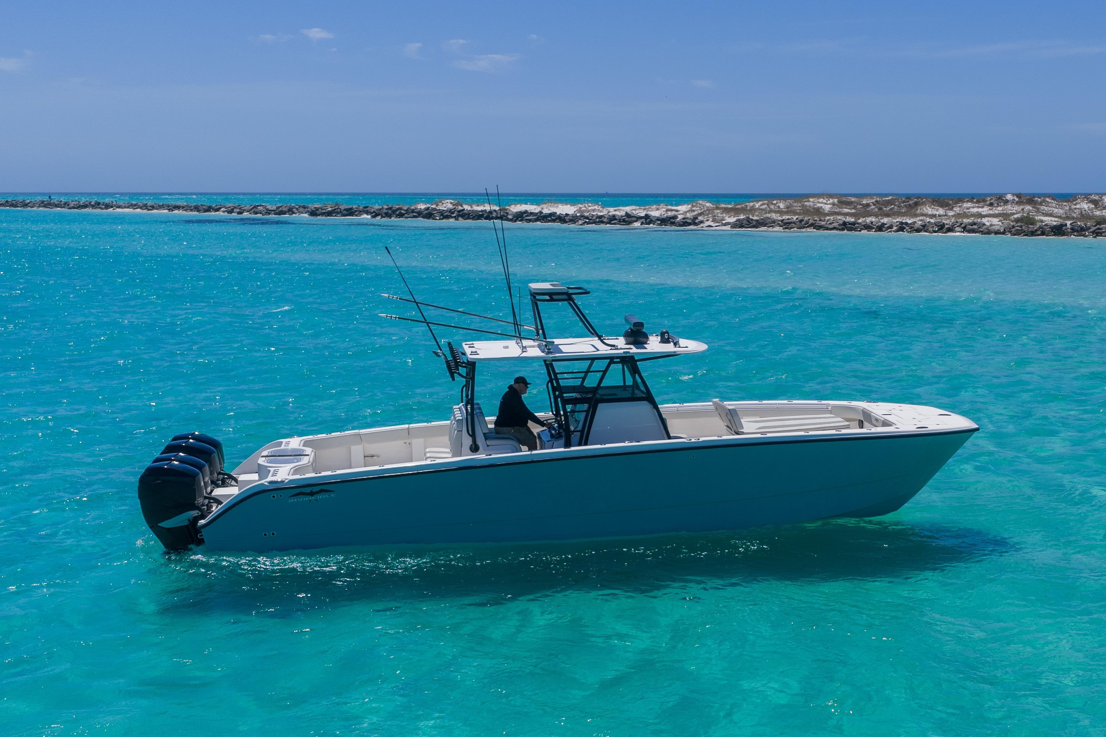 2019 Invincible 40 Catamaran cruising in clear turquoise waters.