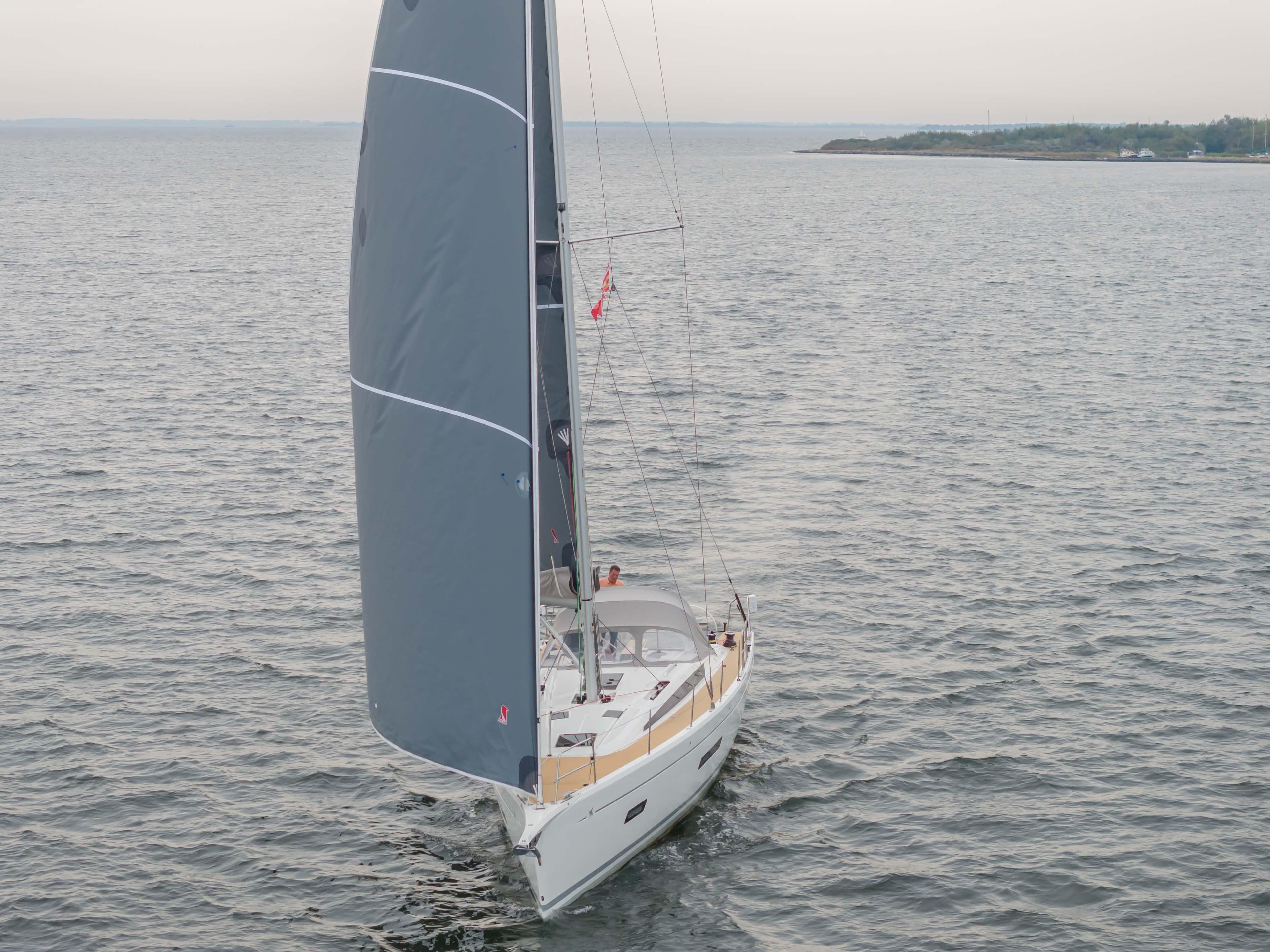 Italia Yachts 12.98 sailing on open water, 2023 model, with sleek design and gray sails.