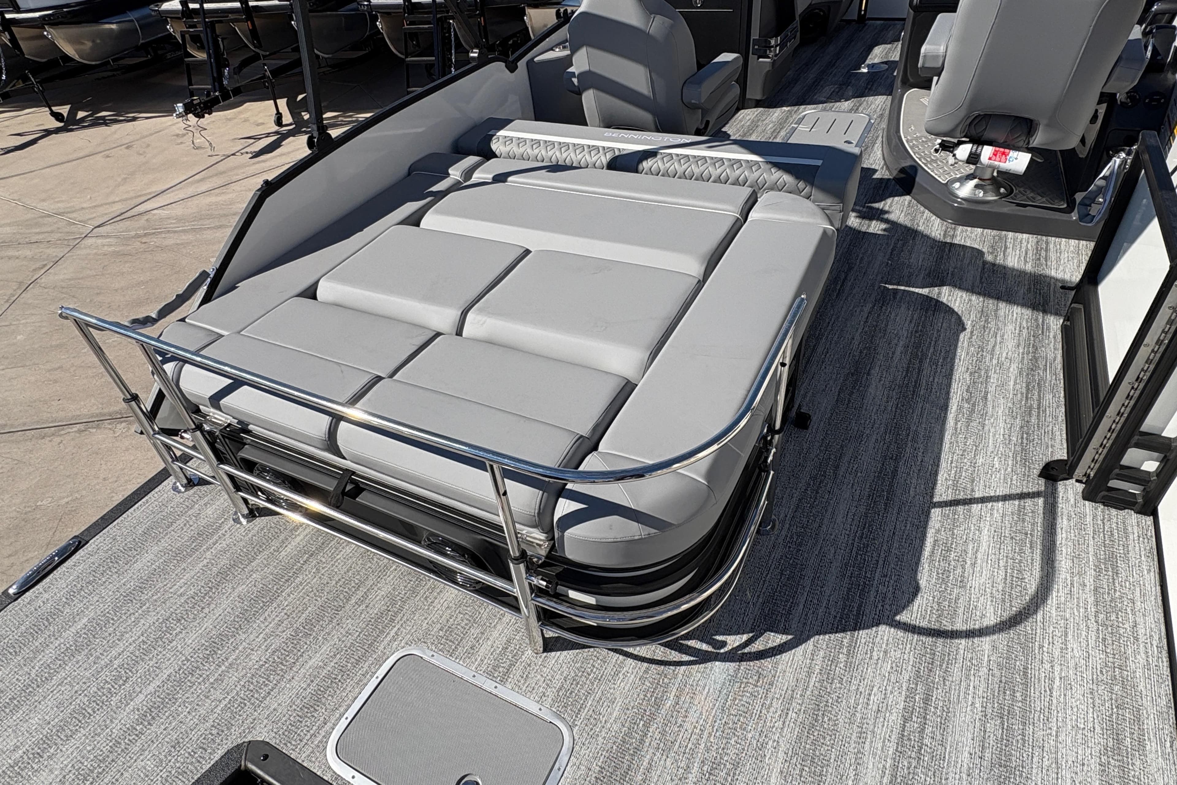2026 Bennington 22 MSB pontoon boat with spacious gray seating and sleek design.