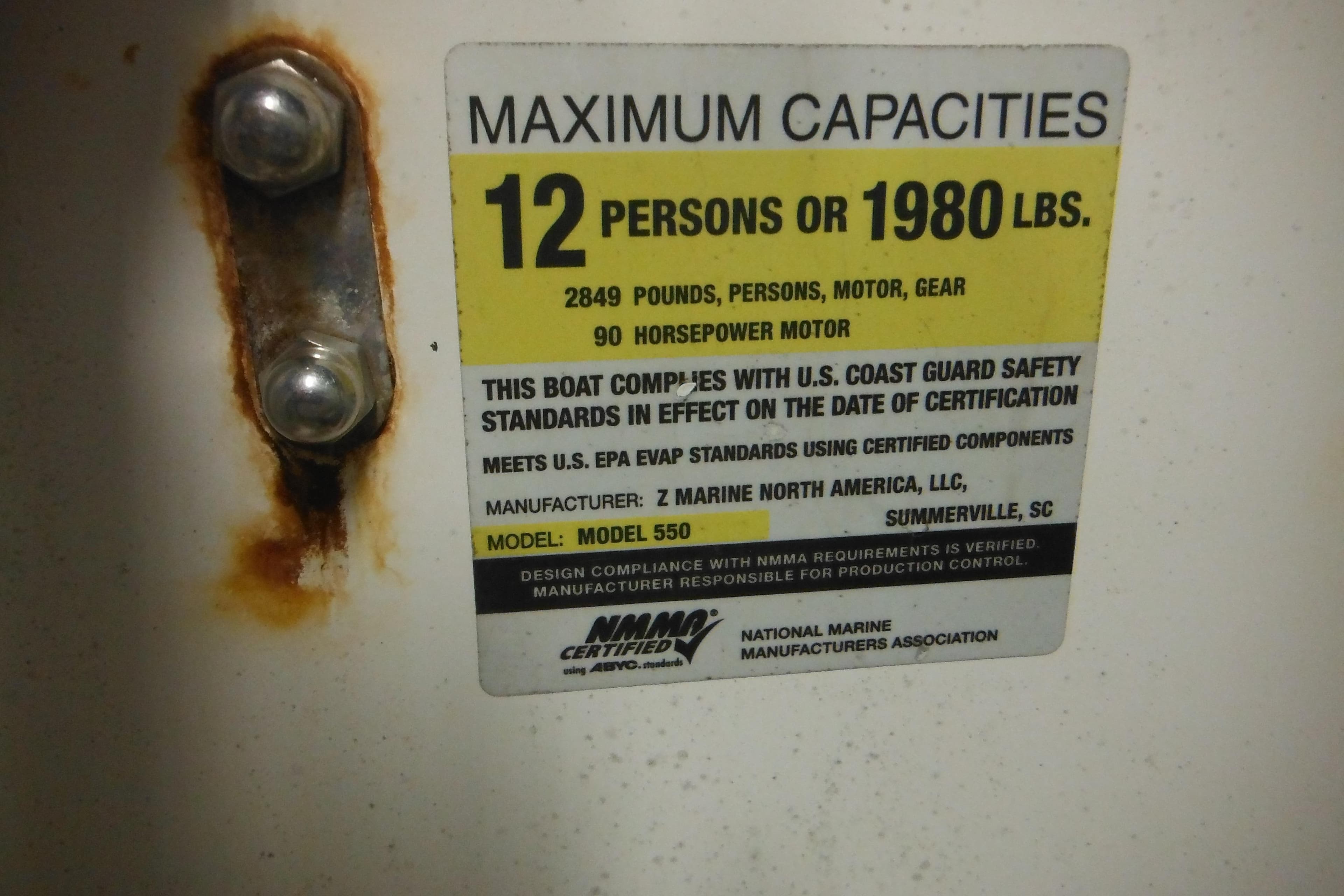 Zodiac Pro 550 capacity label, 12 persons or 1980 lbs, 90 horsepower motor, 2014 model.