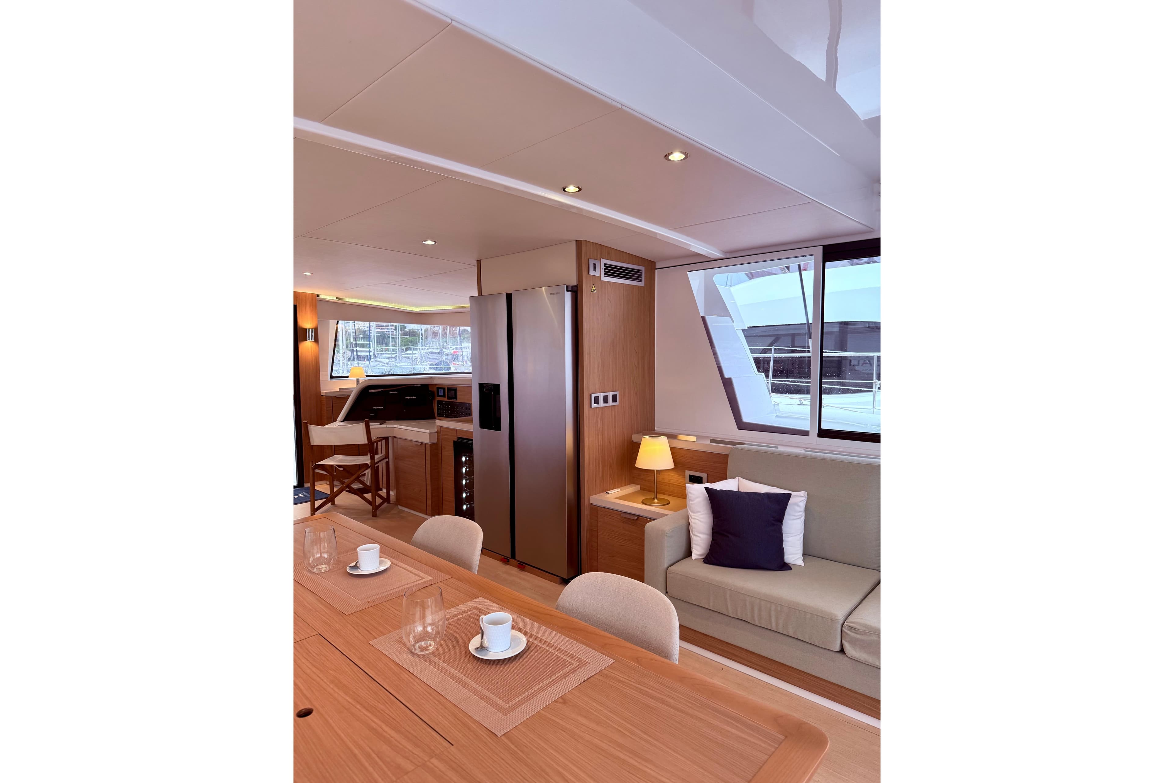 Luxurious interior of 2023 Bali 5.4 yacht with modern kitchen and cozy seating area.