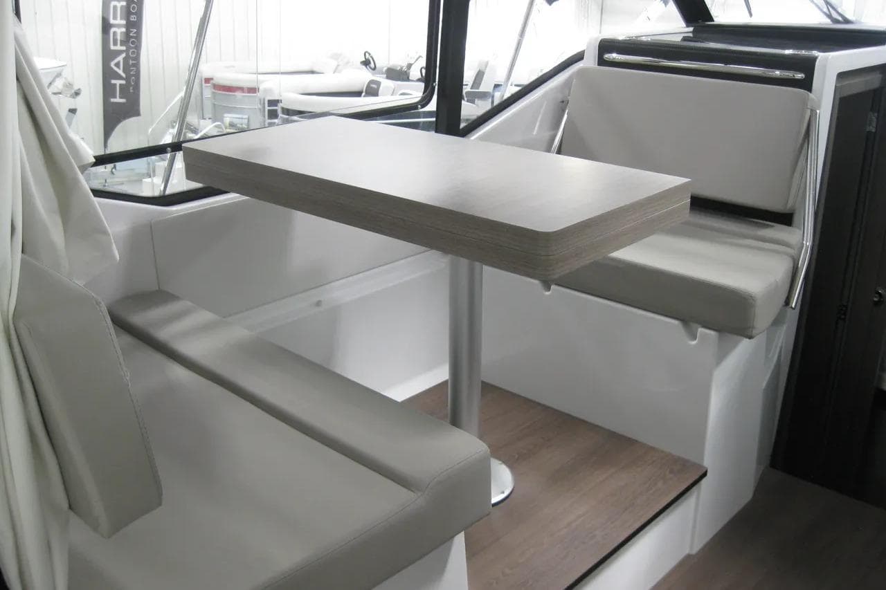 Interior of 2026 Jeanneau NC 895 Series 2, featuring a modern dining area with cushioned seating.