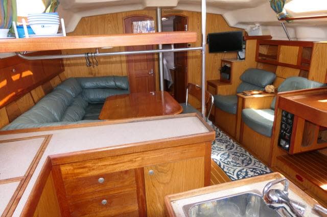 Interior of 2000 Hunter 460 yacht with wood finish and cozy seating area.