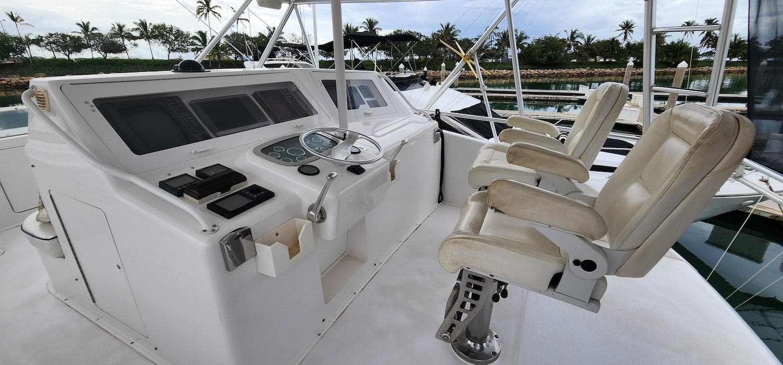 Helm of 2000 Viking 55 Convertible yacht with control panel and seating.