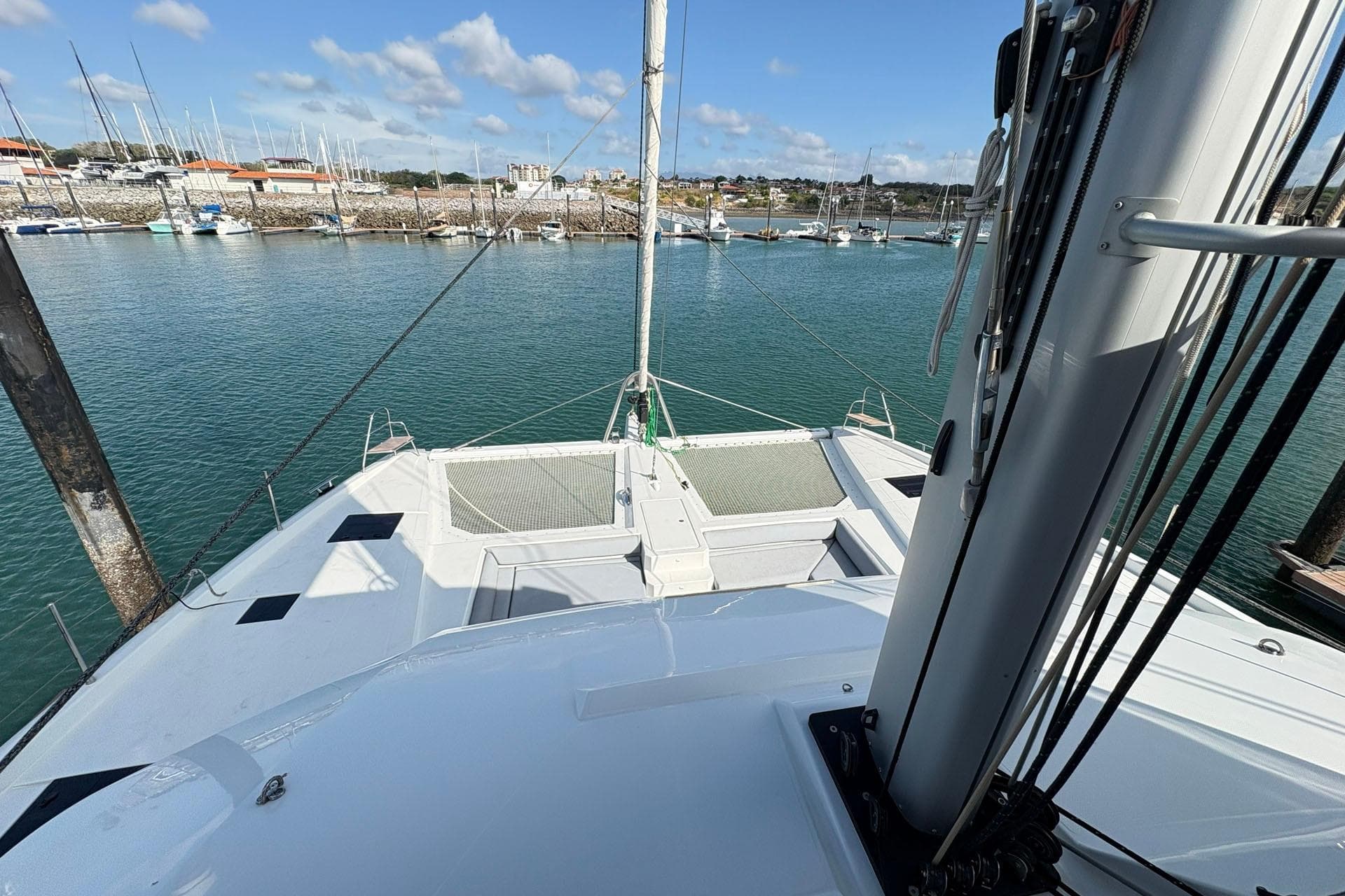 Fountaine Pajot Samana 59 yacht, 2025 model, docked in a marina with clear skies.