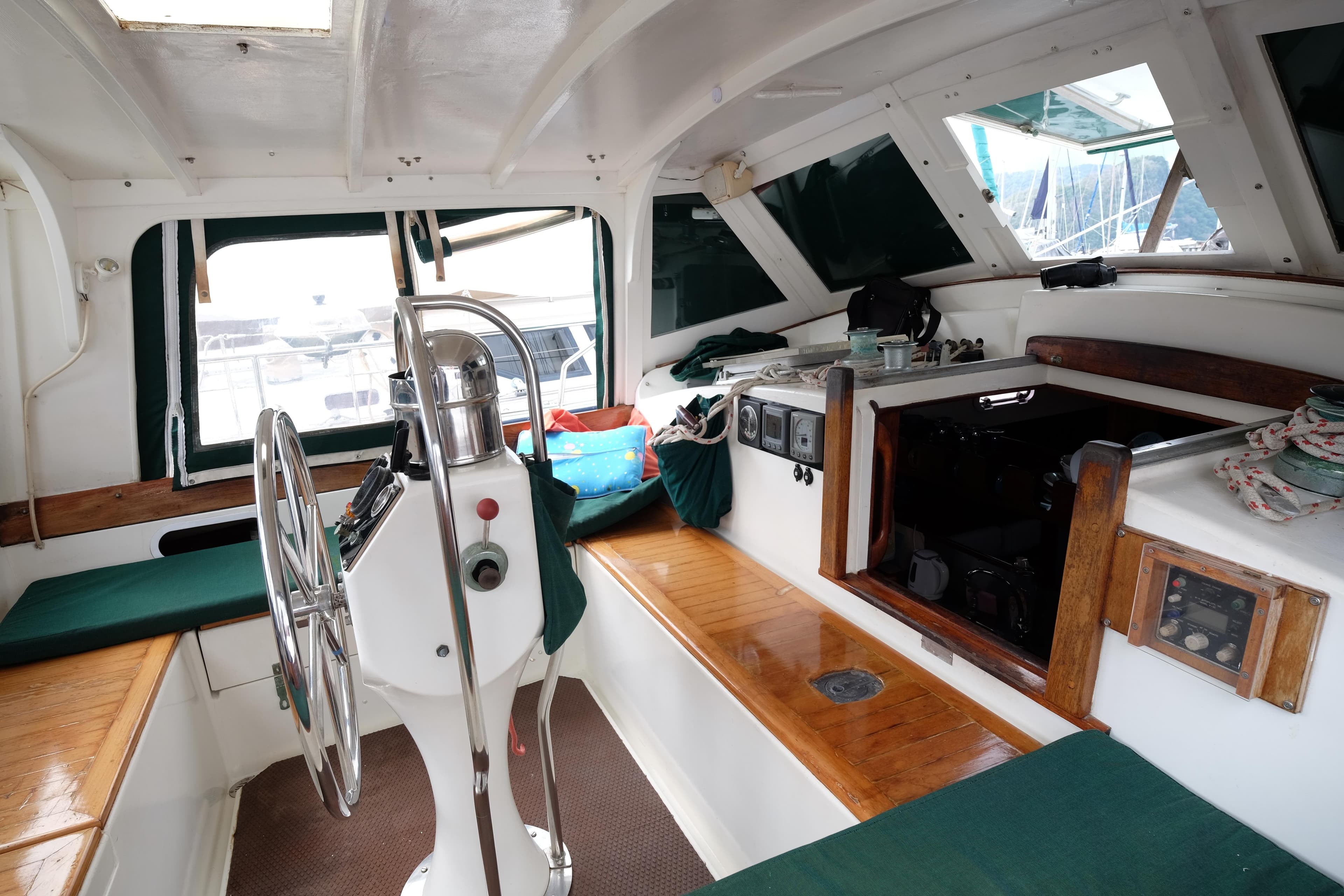 Interior of 1981 Whitby 42 sailboat with helm, seating, and navigation equipment.