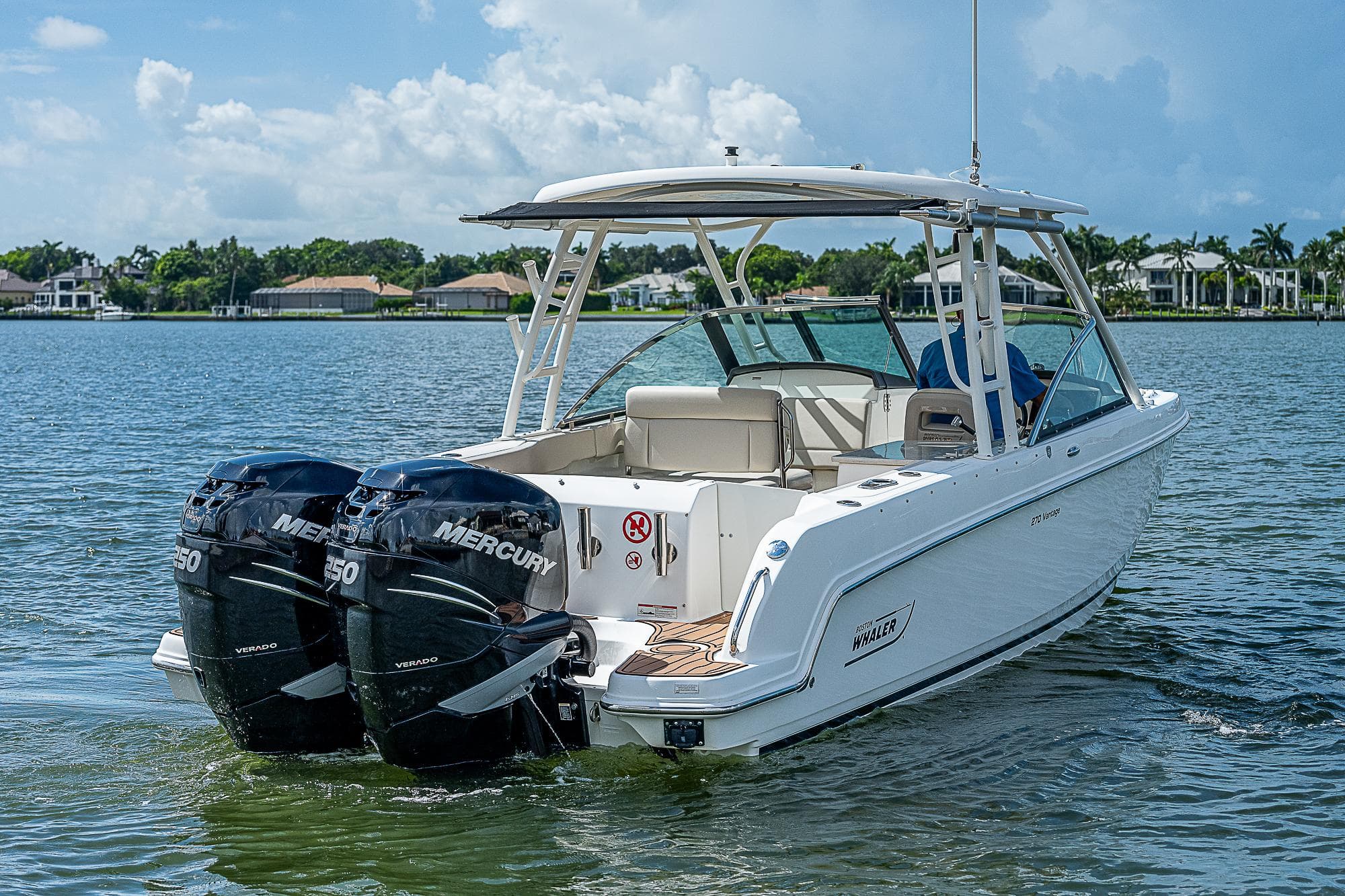 2018 Boston Whaler 270 Vantage boat with twin Mercury engines on a calm lake.