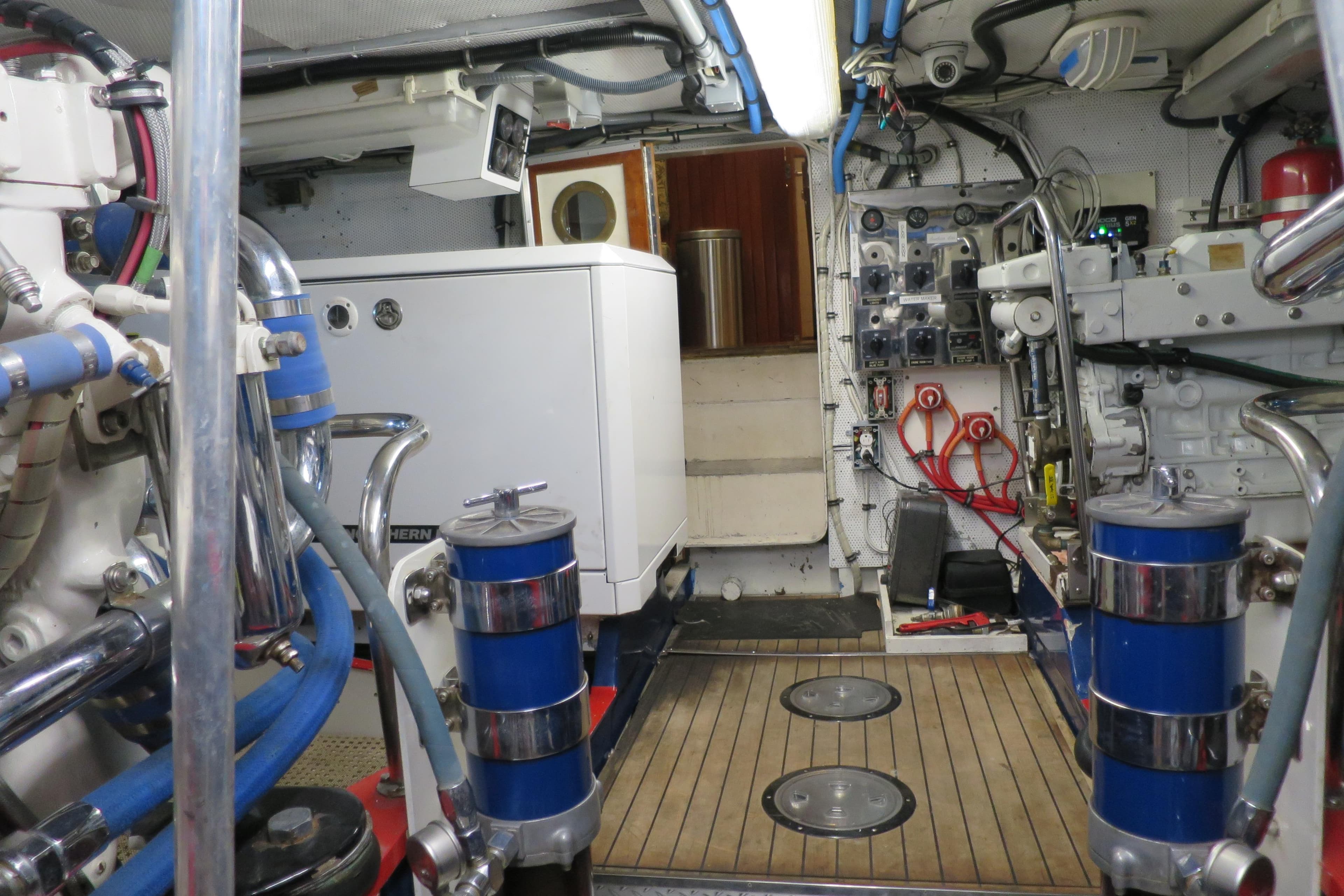Engine room of a 1964 Striker Cockpit boat, featuring machinery and control panels.