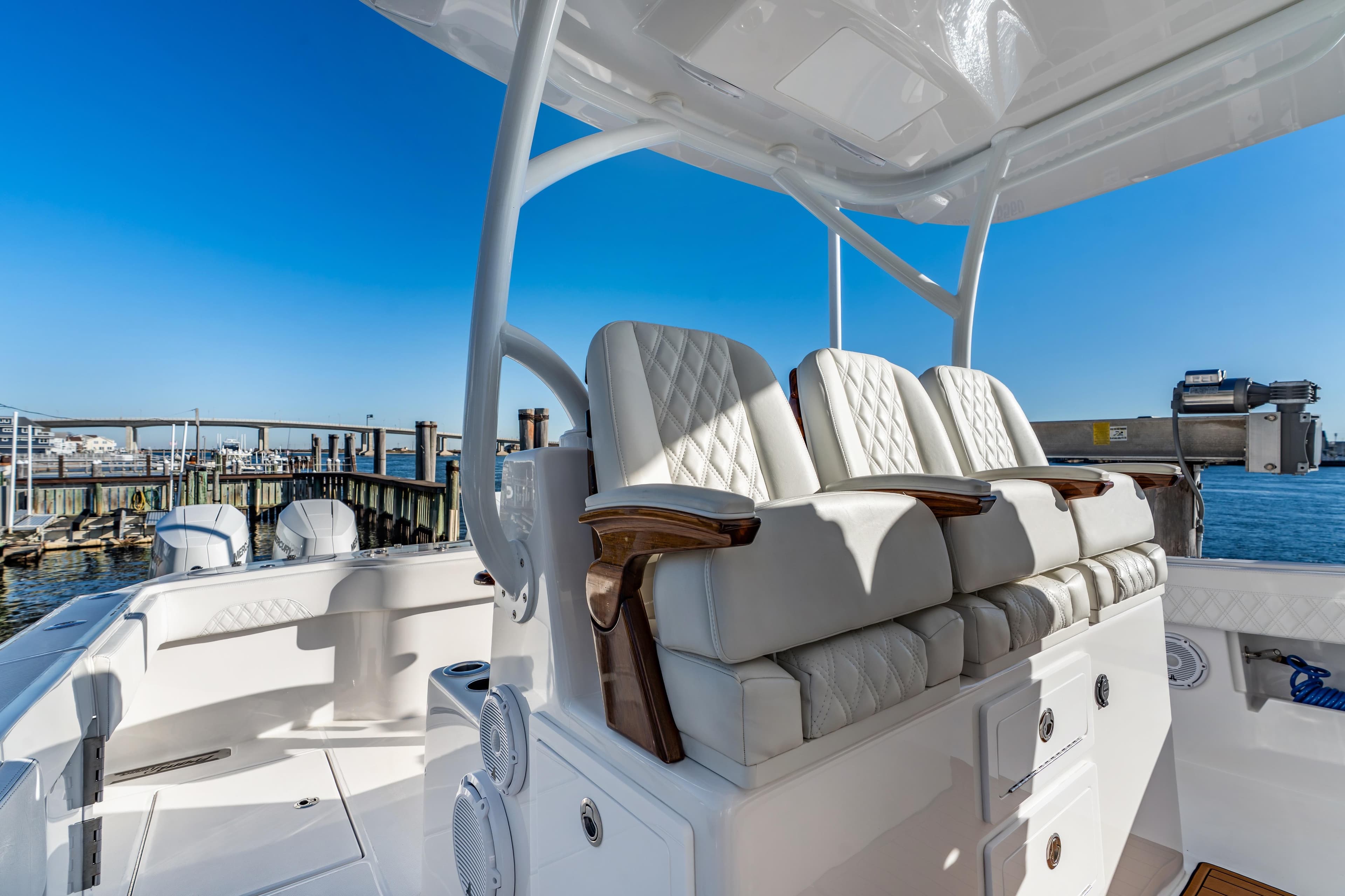 Luxurious seating on 2025 Front Runner 43 Catamaran, docked with clear blue sky backdrop.