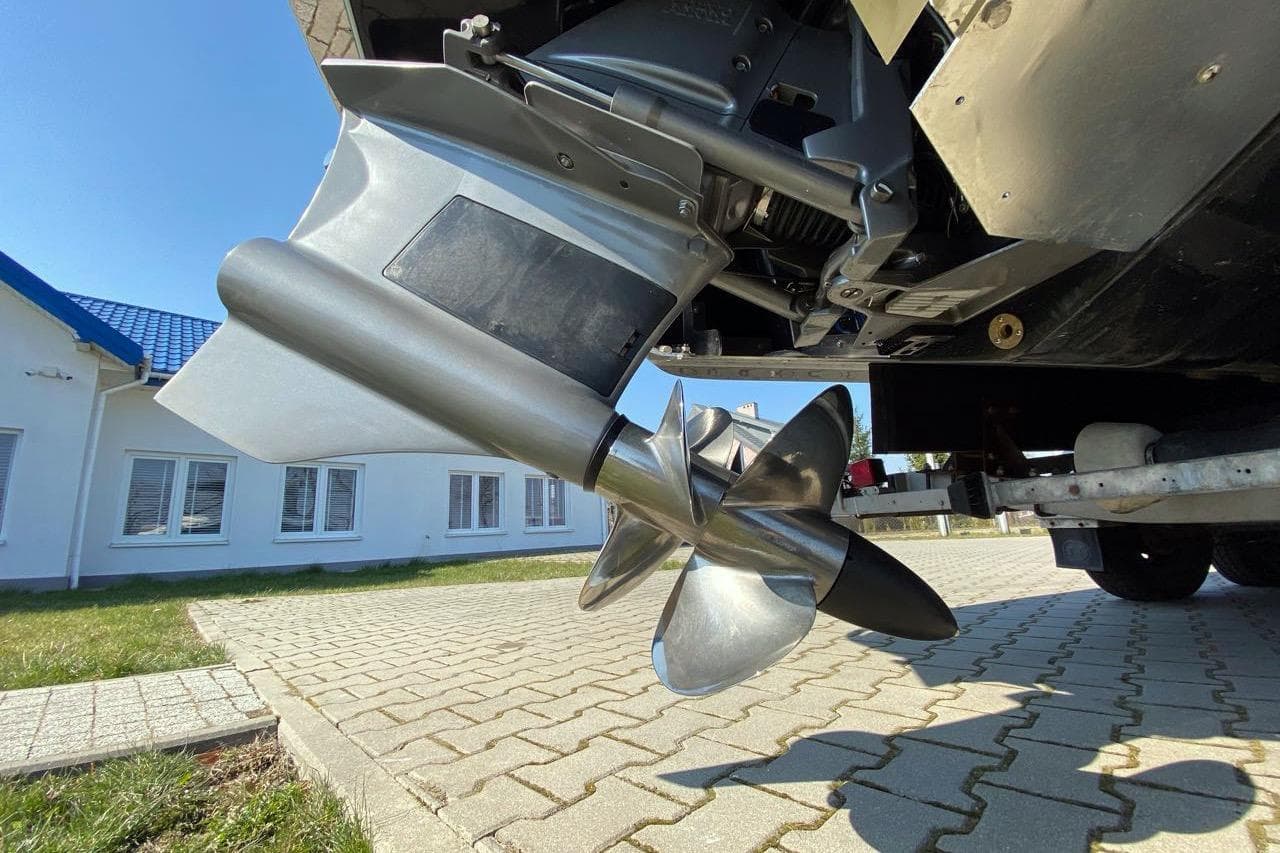 2020 Cobalt R7 Surf boat propeller on a paved driveway, close-up view.
