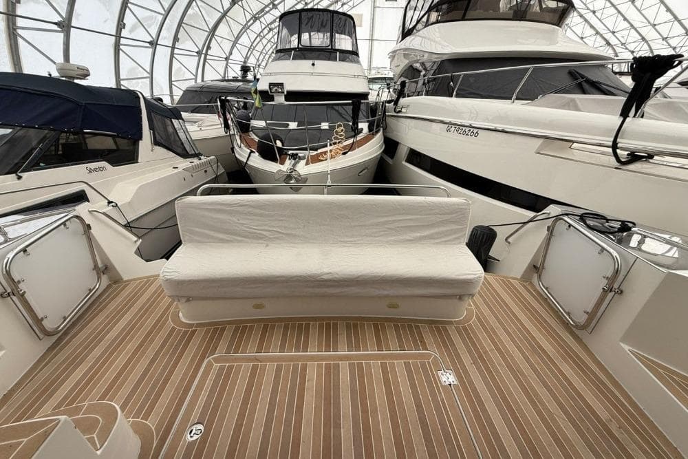 2007 Marquis 55 LS yacht interior with wooden deck and cushioned seating.