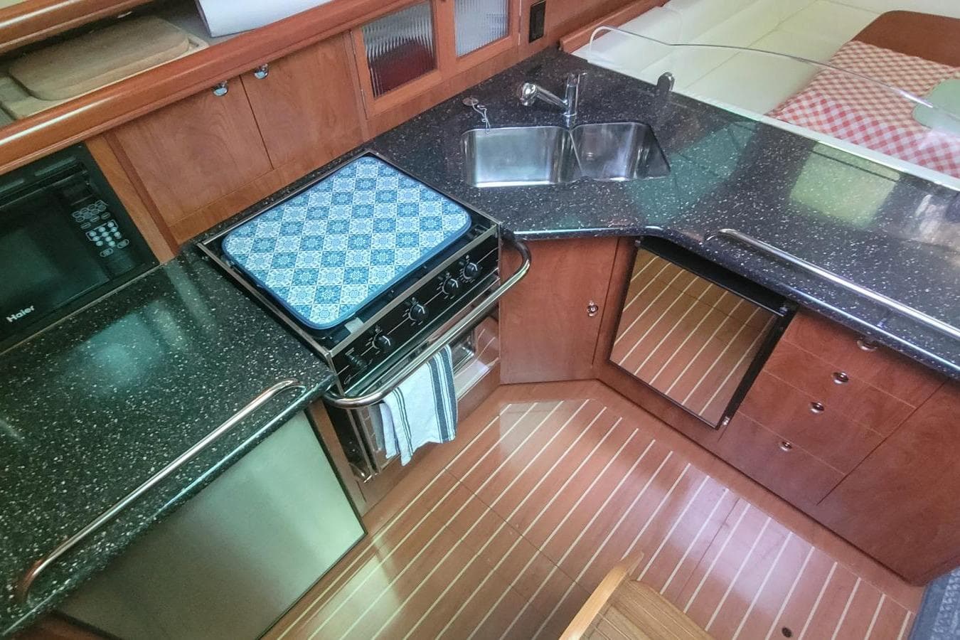 Luxurious kitchen interior of 2012 Hunter 41 Deck Salon yacht with modern appliances.