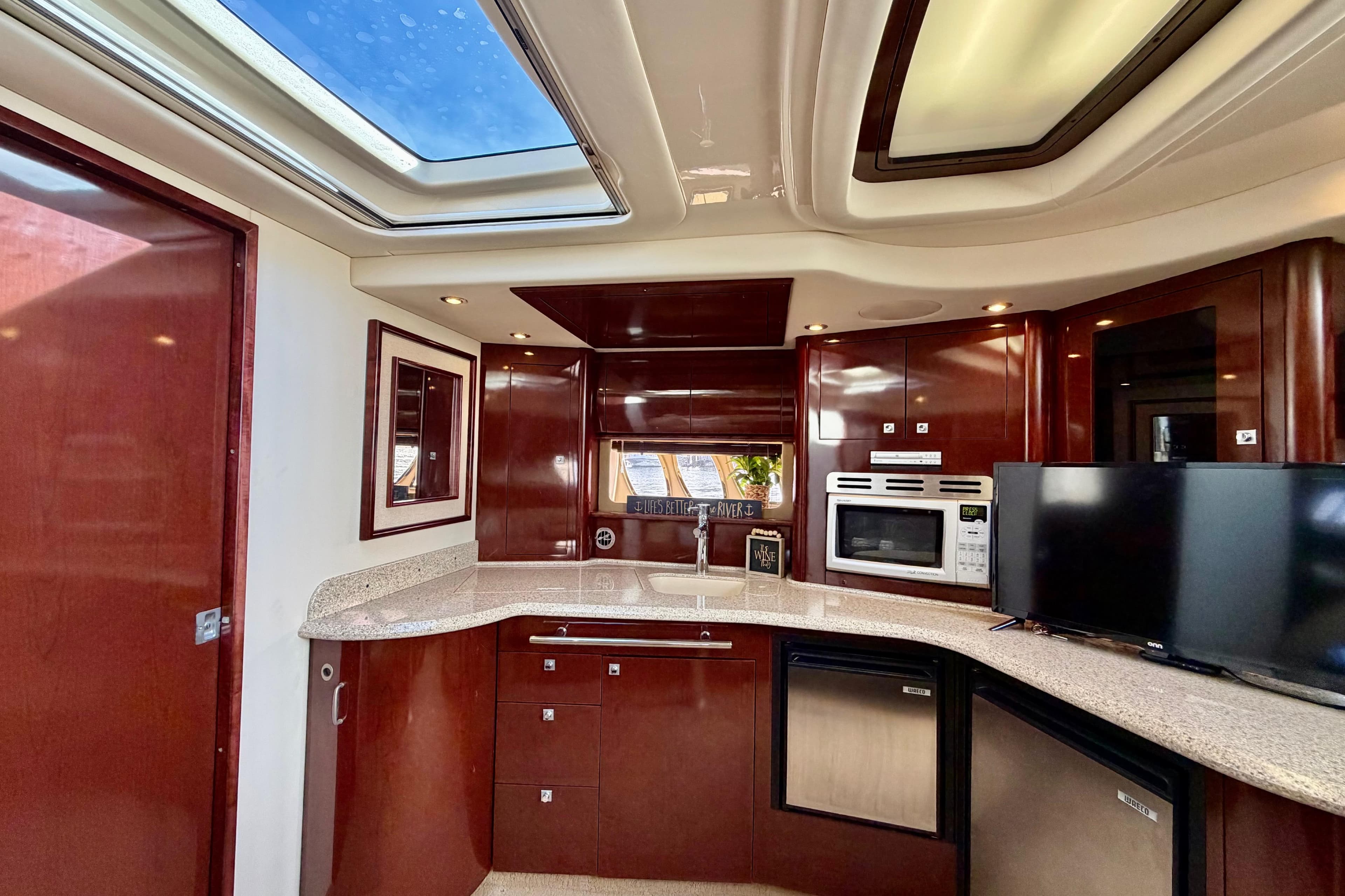 Luxurious 2008 Sea Ray 44 Sundancer yacht interior with modern kitchen amenities.