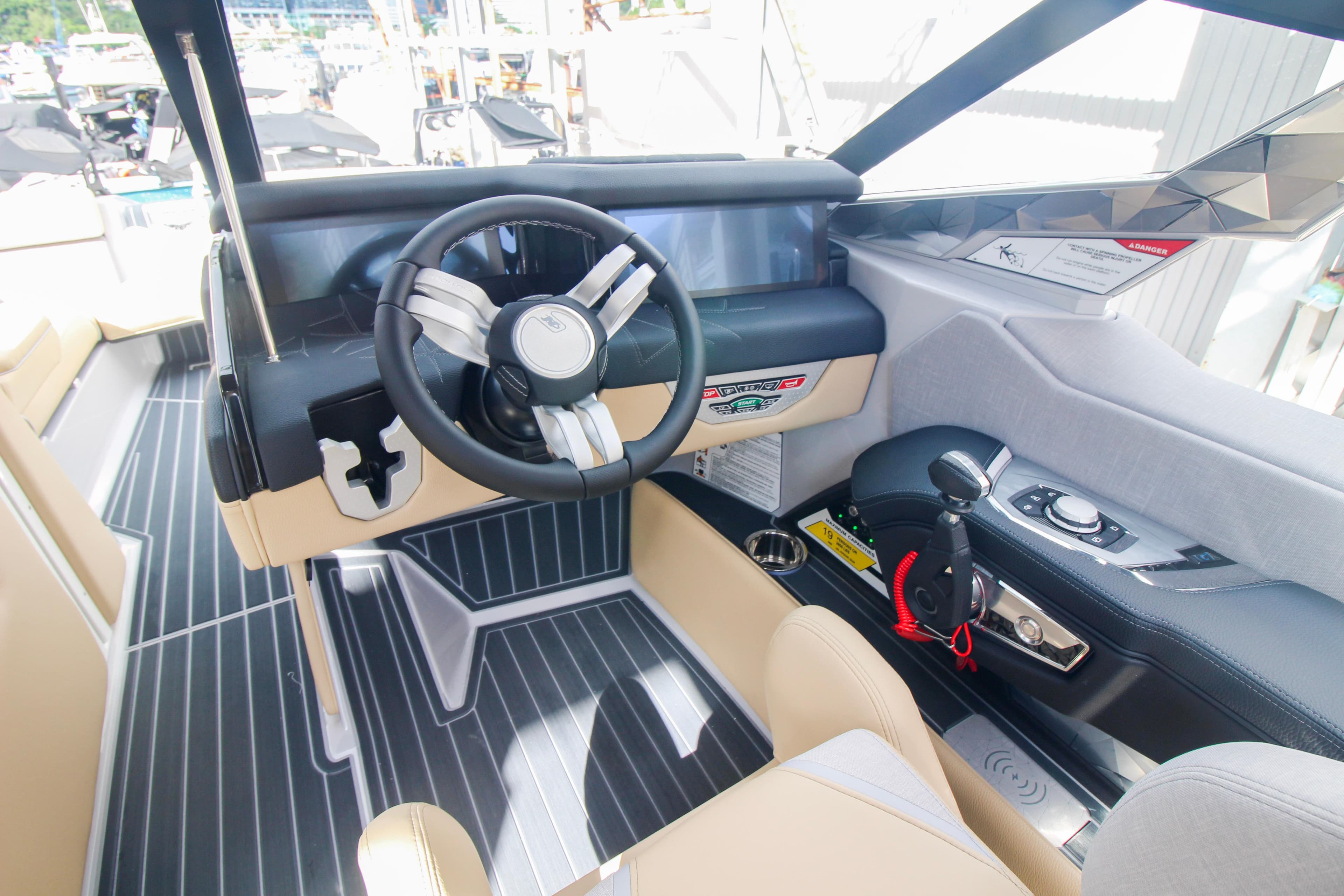 Interior of 2022 Nautique Super Air Nautique G25 Paragon boat, featuring steering wheel and controls.