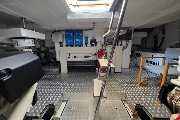 Engine room of 2024 Sirena 58 Flybridge MY yacht with equipment and ladder.