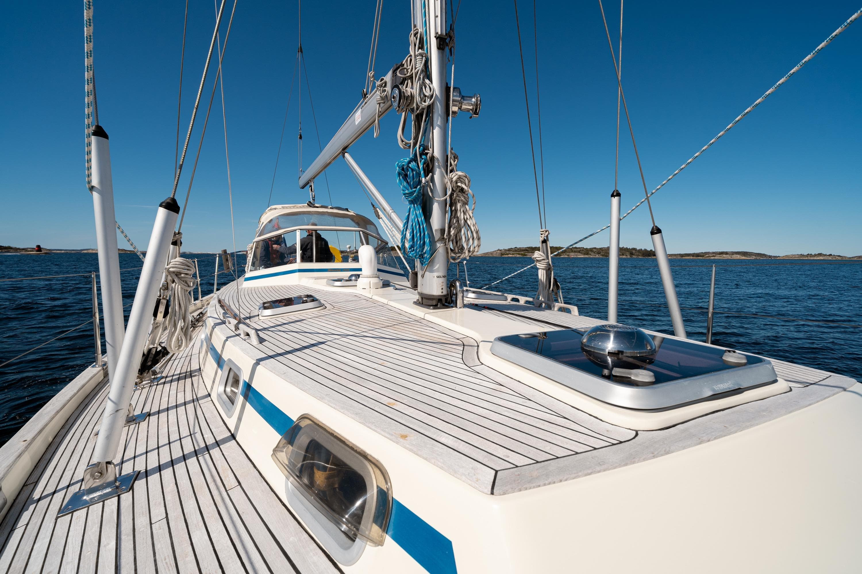 Sailing yacht Malo 42, 1997 model, on open water under clear blue sky.