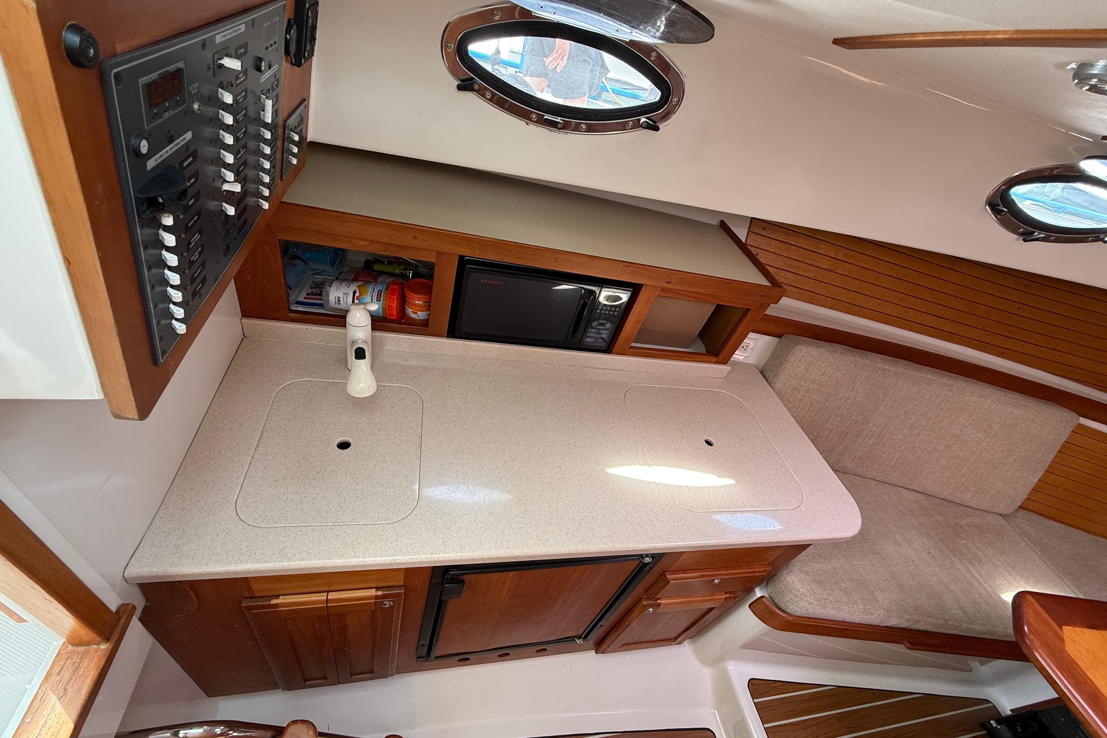 2006 Back Cove 29 interior with kitchenette, microwave, and seating area.