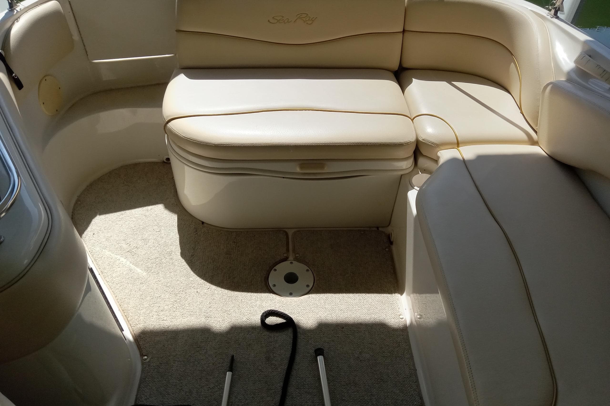 Interior seating of a 2001 Sea Ray 240 Sundeck boat, featuring beige upholstery.