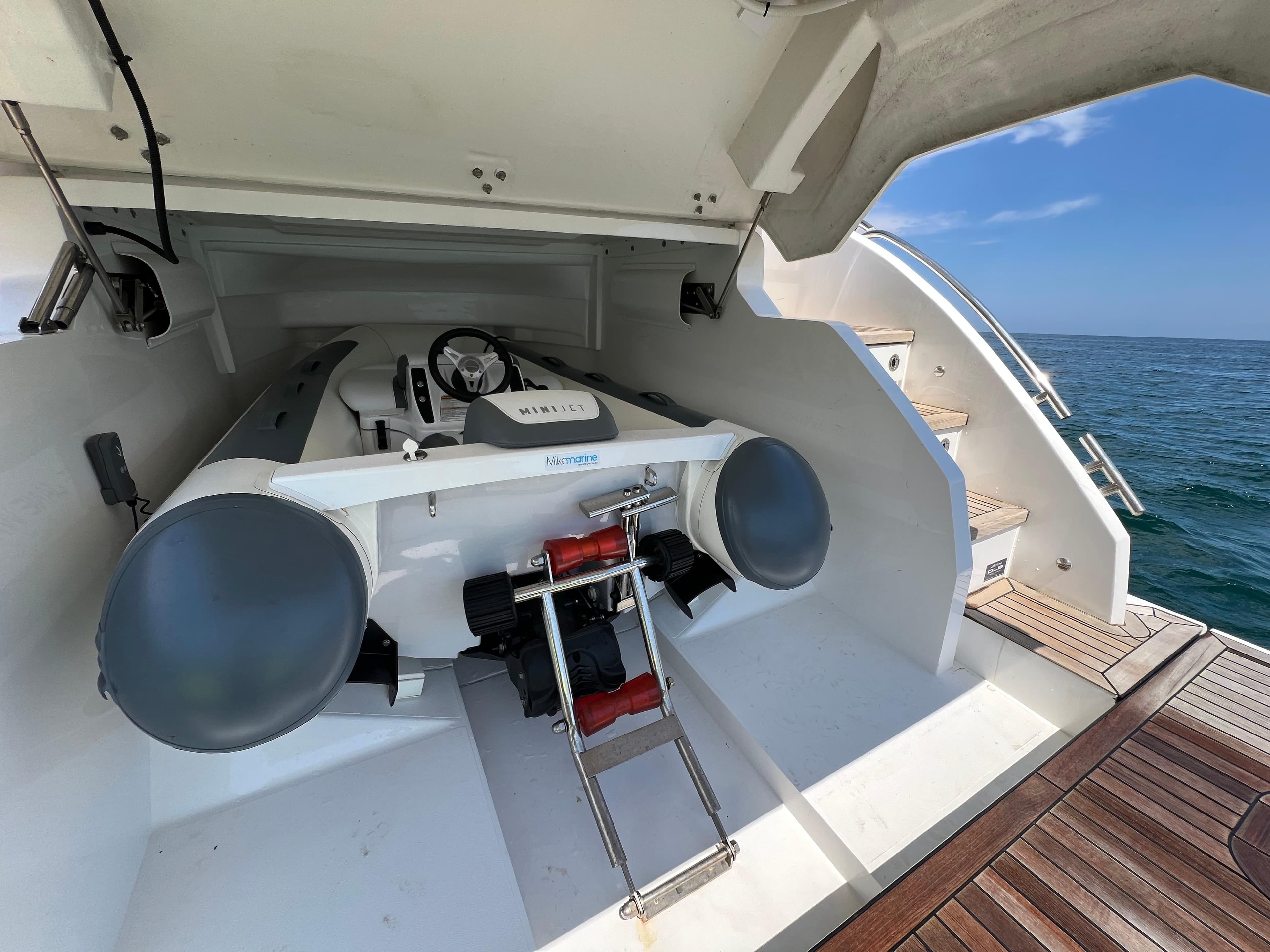Luxury yacht Princess V50 with a stored mini jet boat, 2019 model, on open sea.