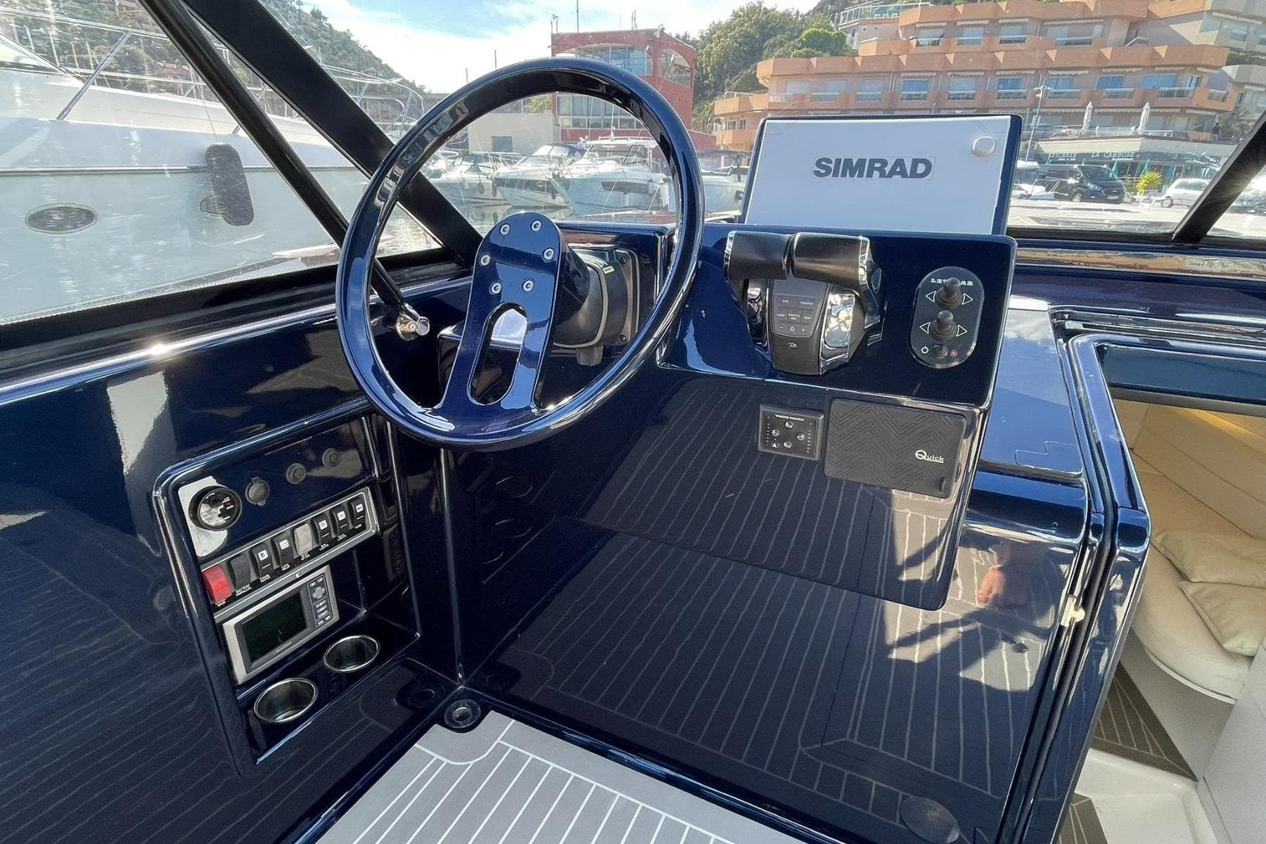 Cockpit of 2015 VanDutch 40 yacht with Simrad navigation system and sleek controls.