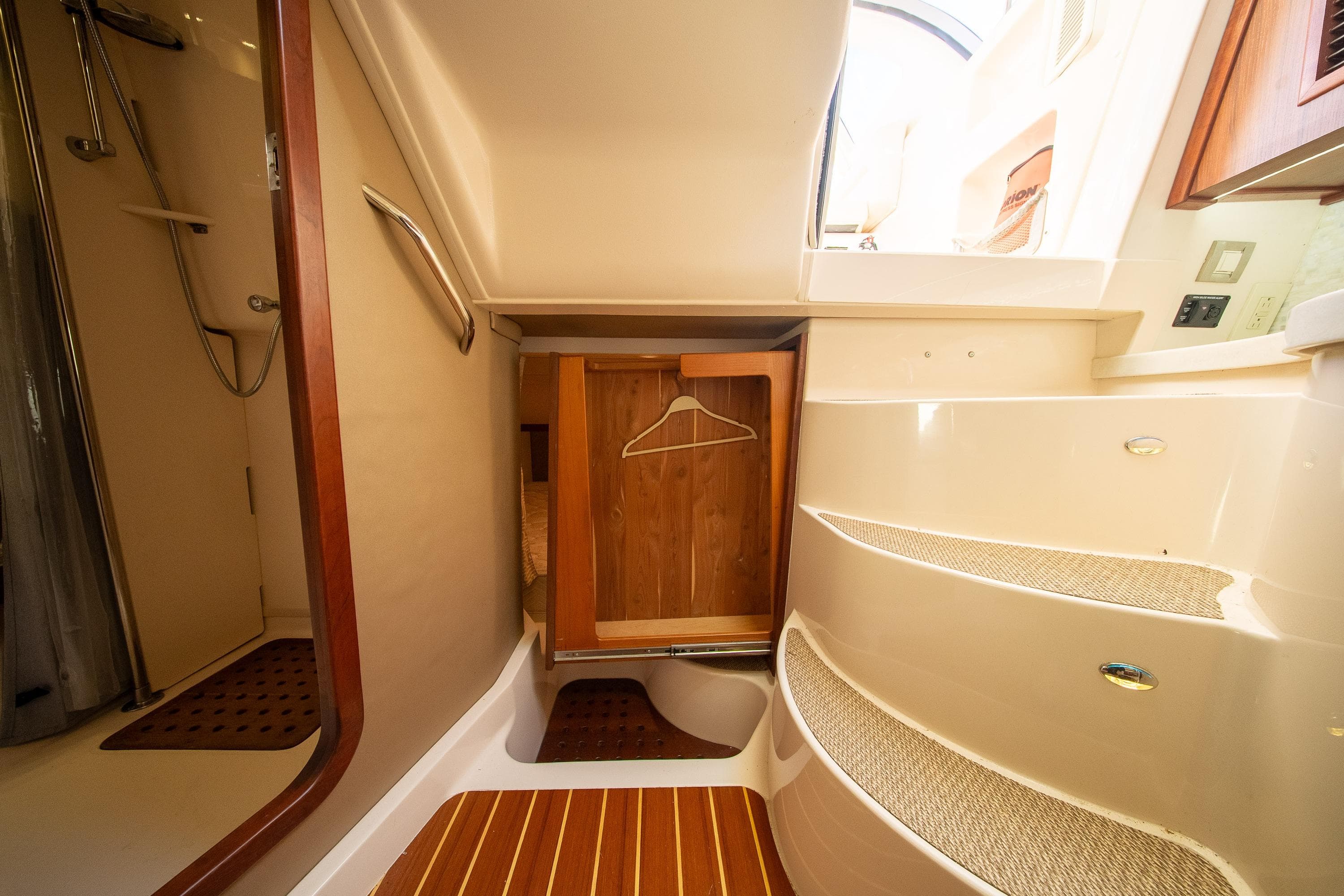 Interior of 2015 Grady-White Express 370 boat, featuring stairs and a wooden closet.