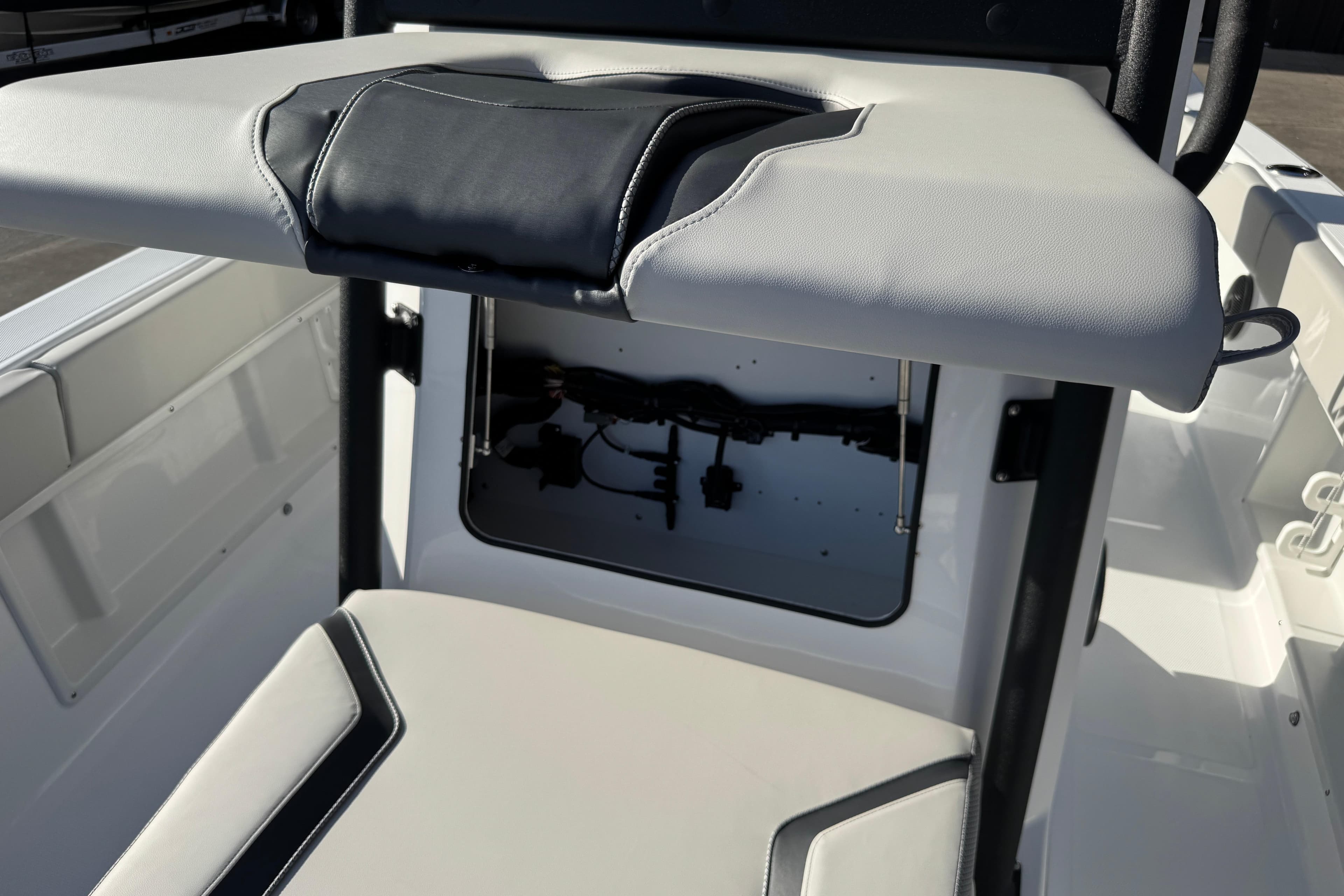 2026 Scarab 235 Open SE boat interior with storage compartment and cushioned seating.
