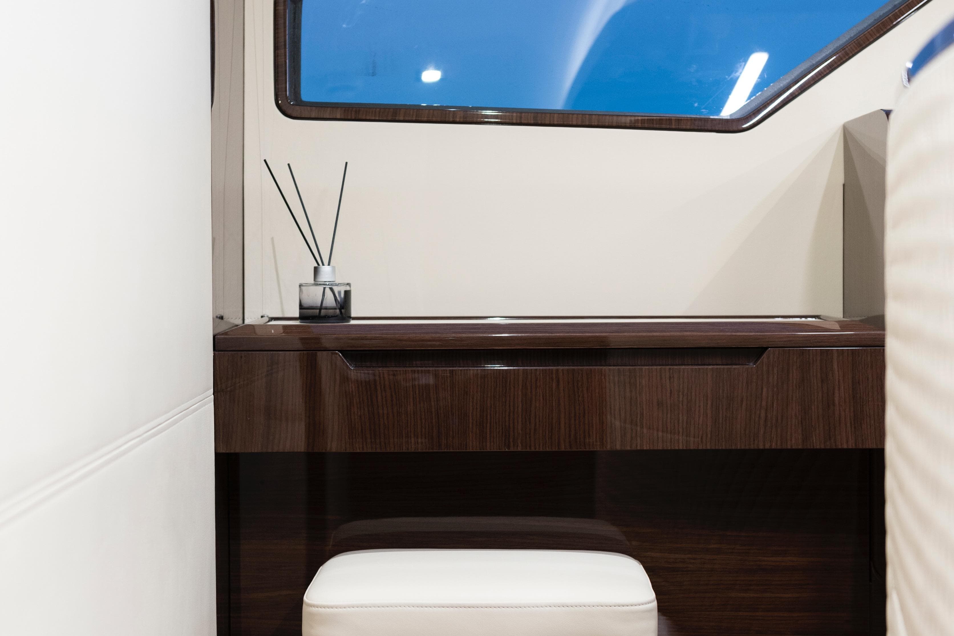 Luxurious interior of 2027 Lazzara LSX 67 yacht with elegant wood finish and modern decor.