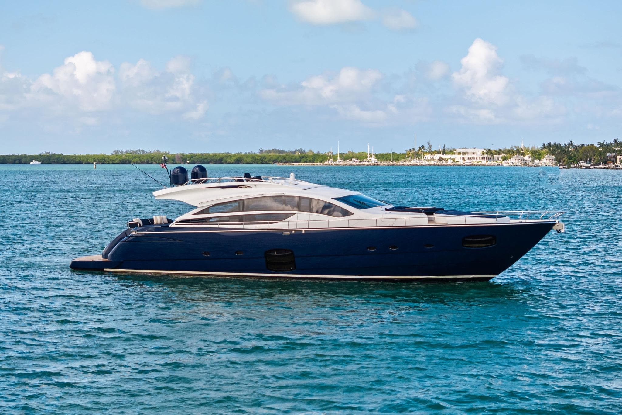 Luxurious 2013 Pershing 82 yacht cruising on serene blue waters.