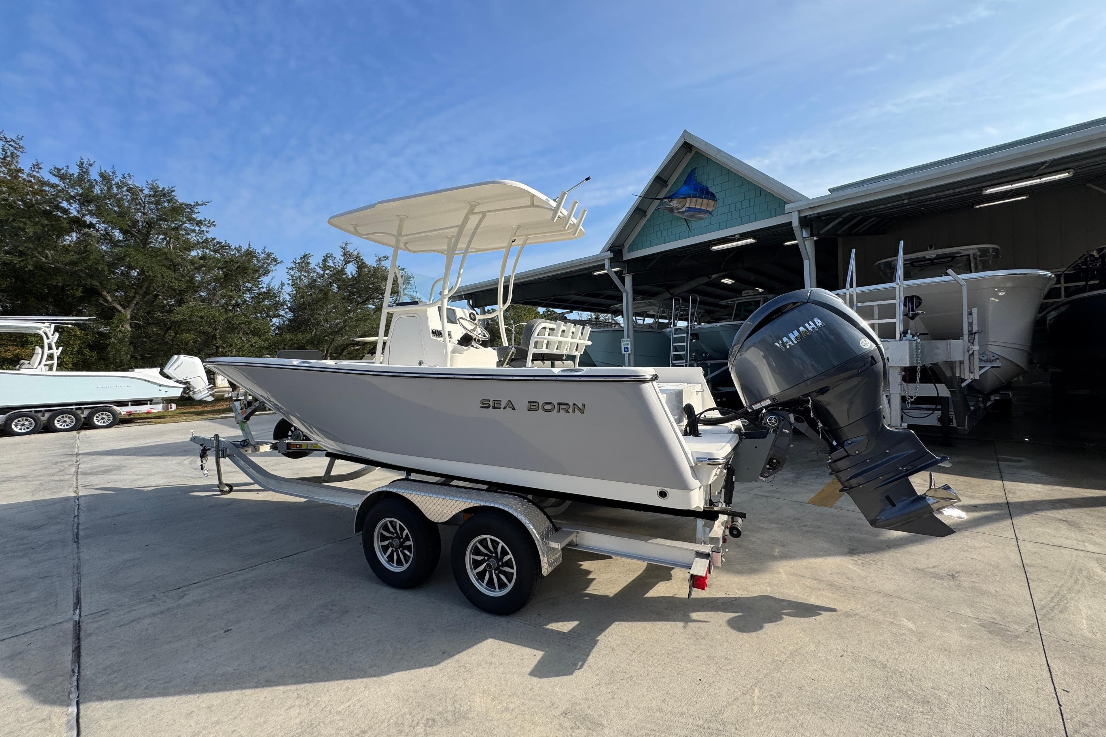 2026 Sea Born LX21 Center Console boat on trailer, parked outdoors.