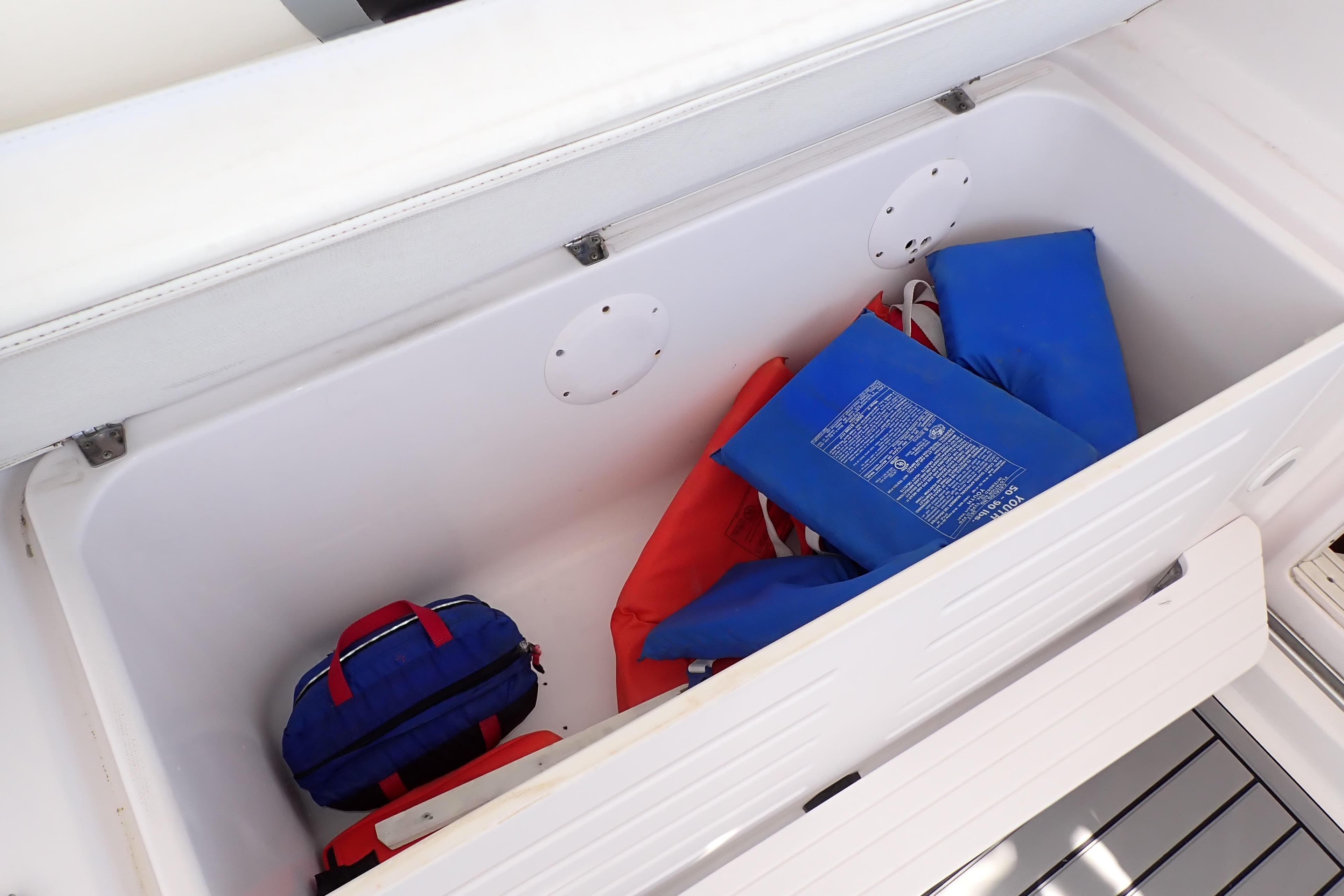 Storage compartment on 2014 Pro-Line 32 Express boat with life jackets and gear.