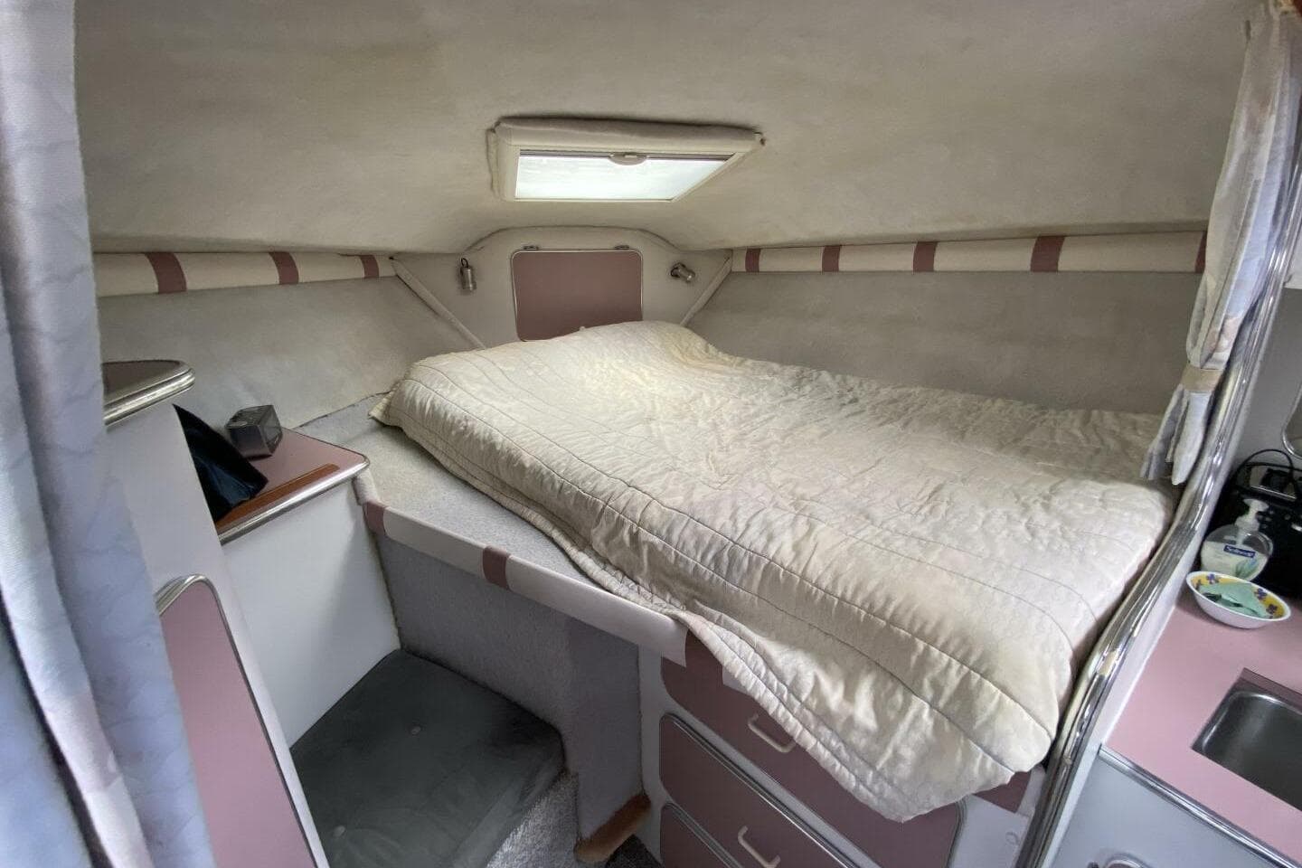 1988 Chris-Craft 332 Amerosport cabin interior with bed and storage.