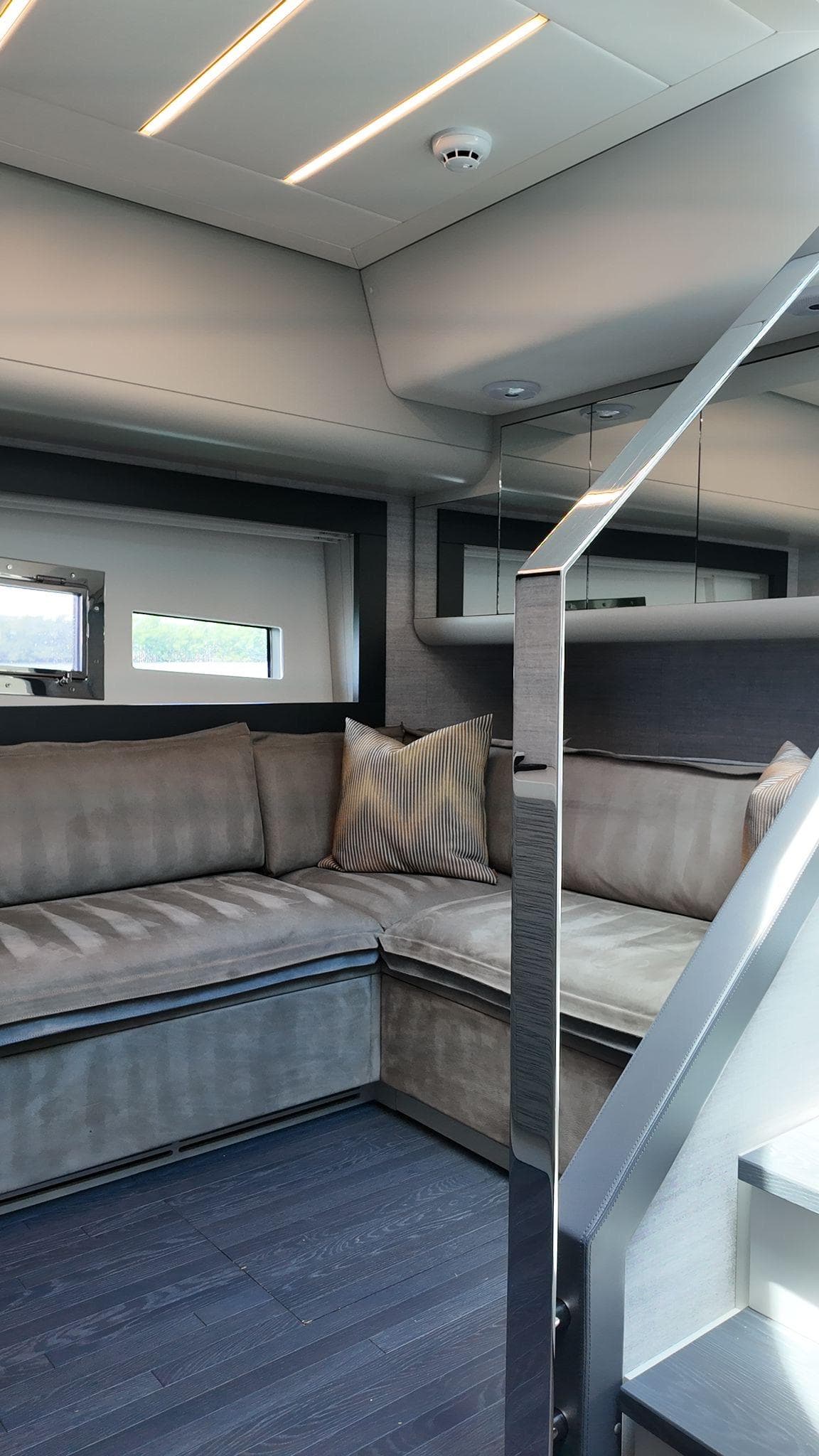 Luxurious interior of 2022 Pershing 6X yacht with modern seating and sleek design.