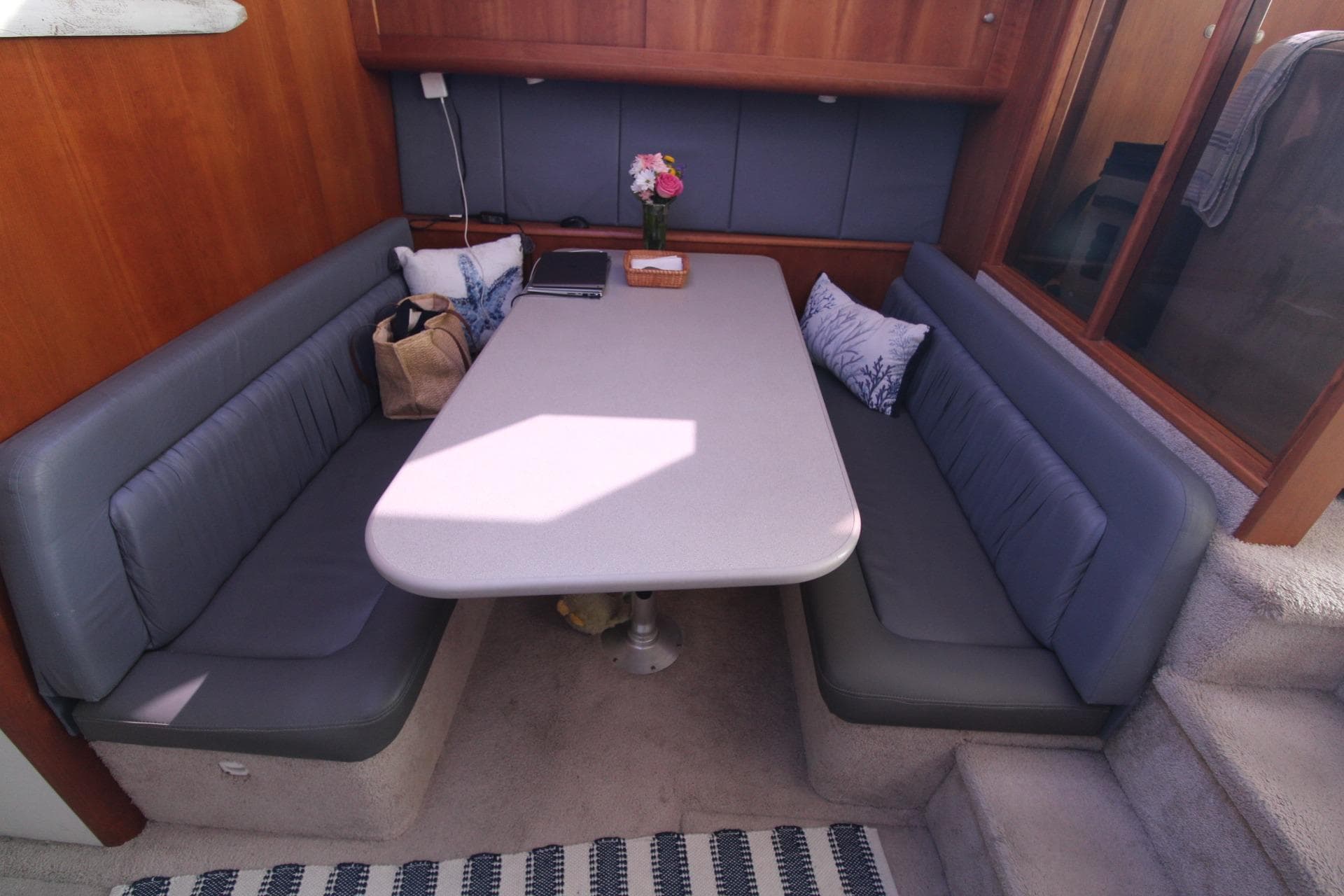 Interior of 1996 Silverton 41 Convertible yacht with cozy dining area.