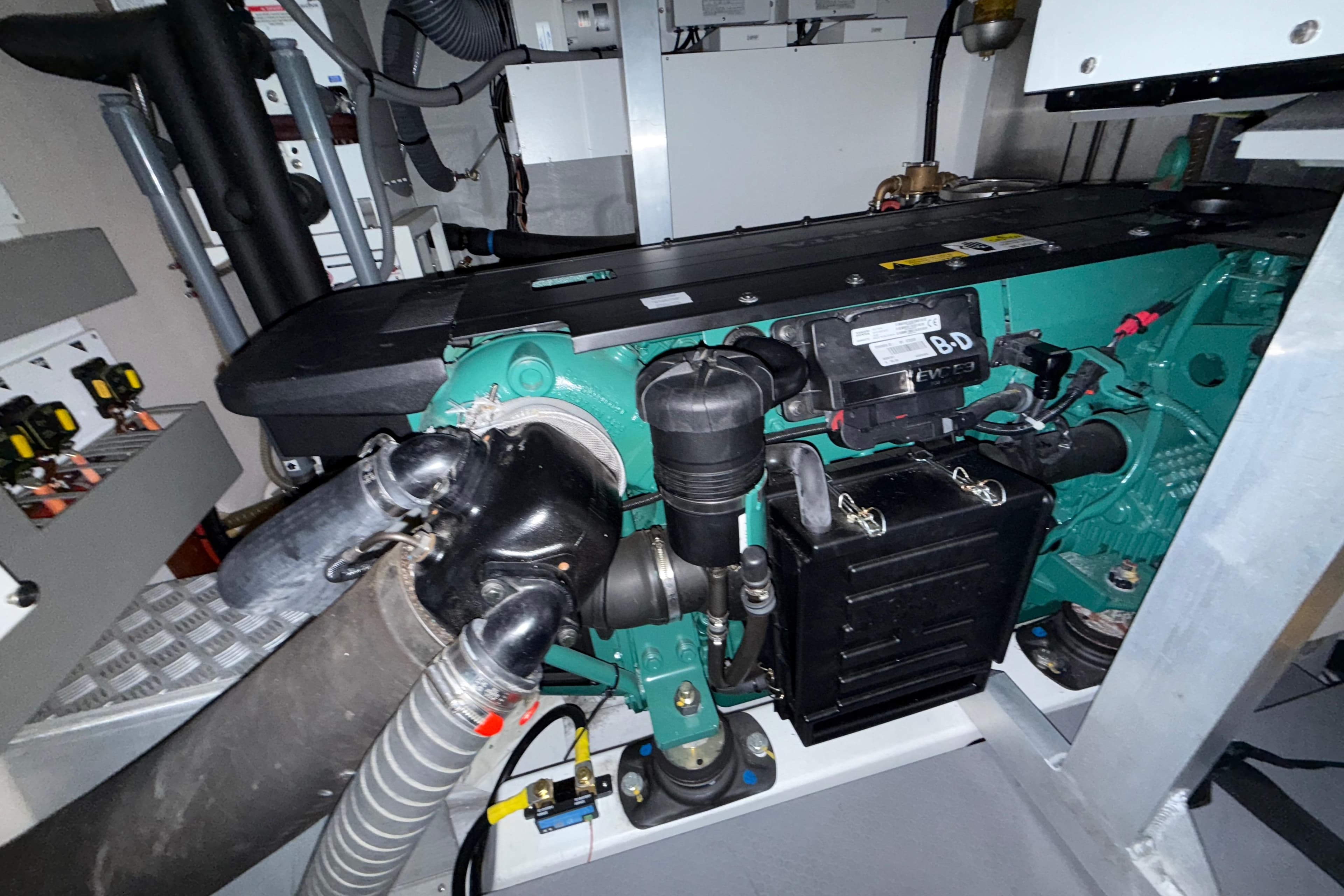 Engine room of a 2018 Beneteau Swift Trawler 50, showcasing detailed machinery components.