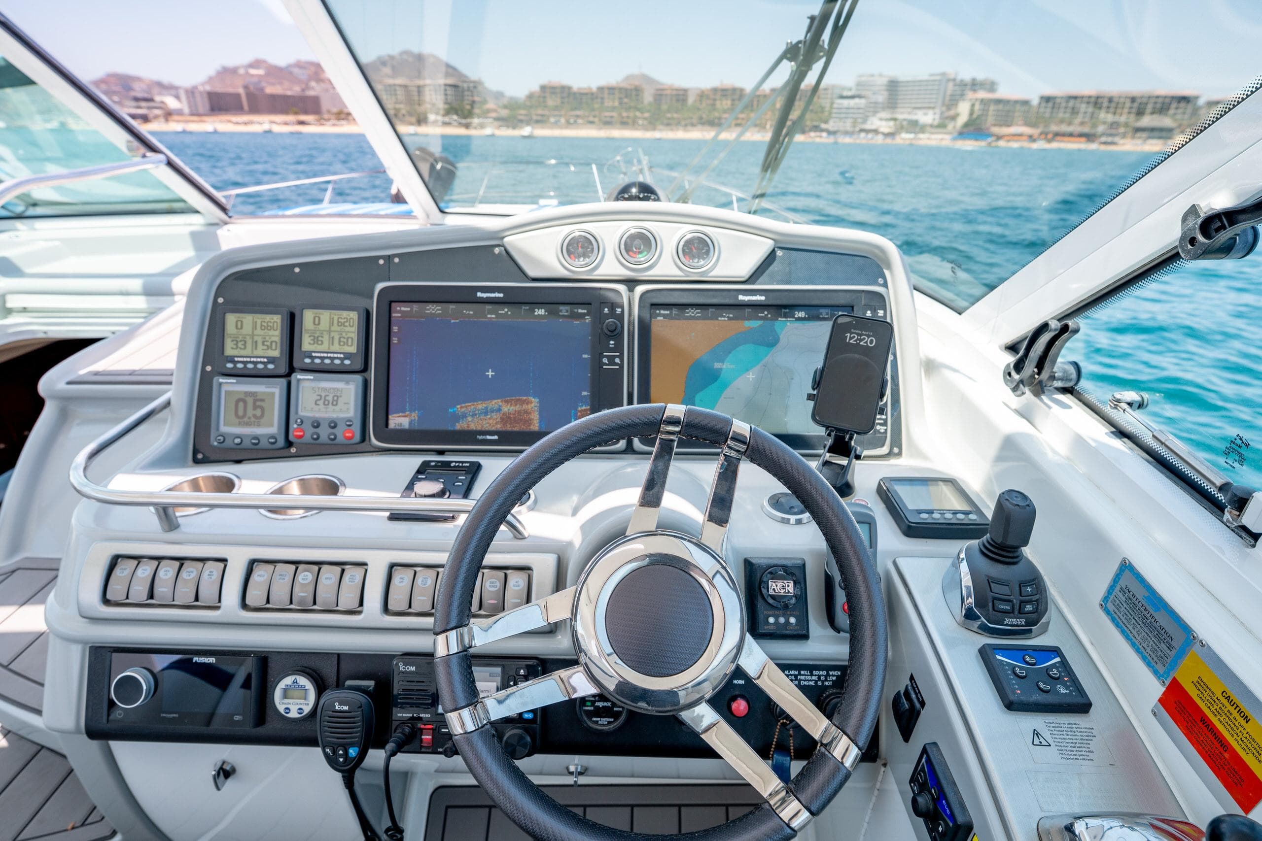 Helm of 2007 Formula 45 Yacht with navigation screens and controls, overlooking ocean view.