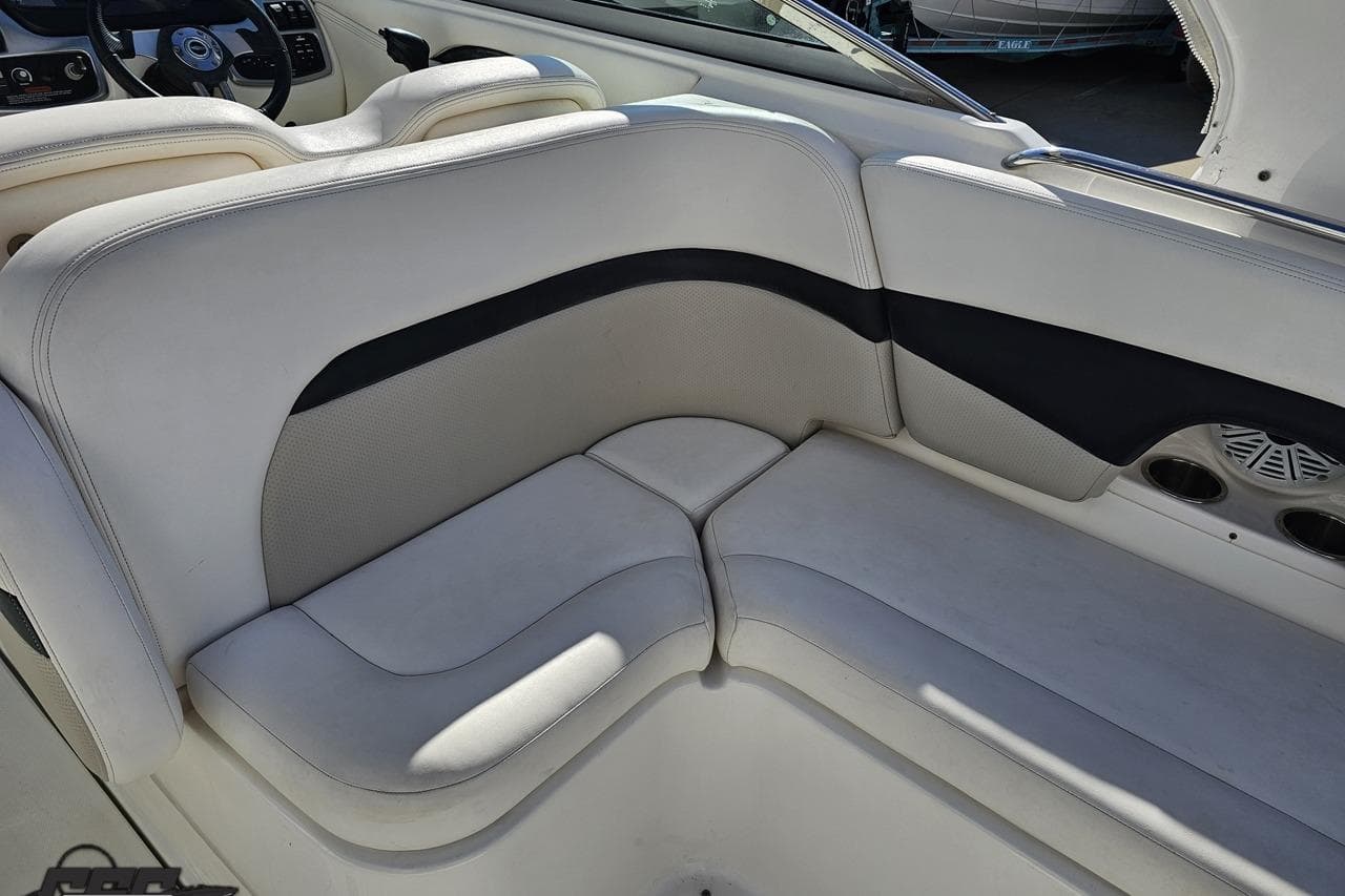 Interior seating of a 2010 Chaparral 276 SSX boat, featuring white and black upholstery.