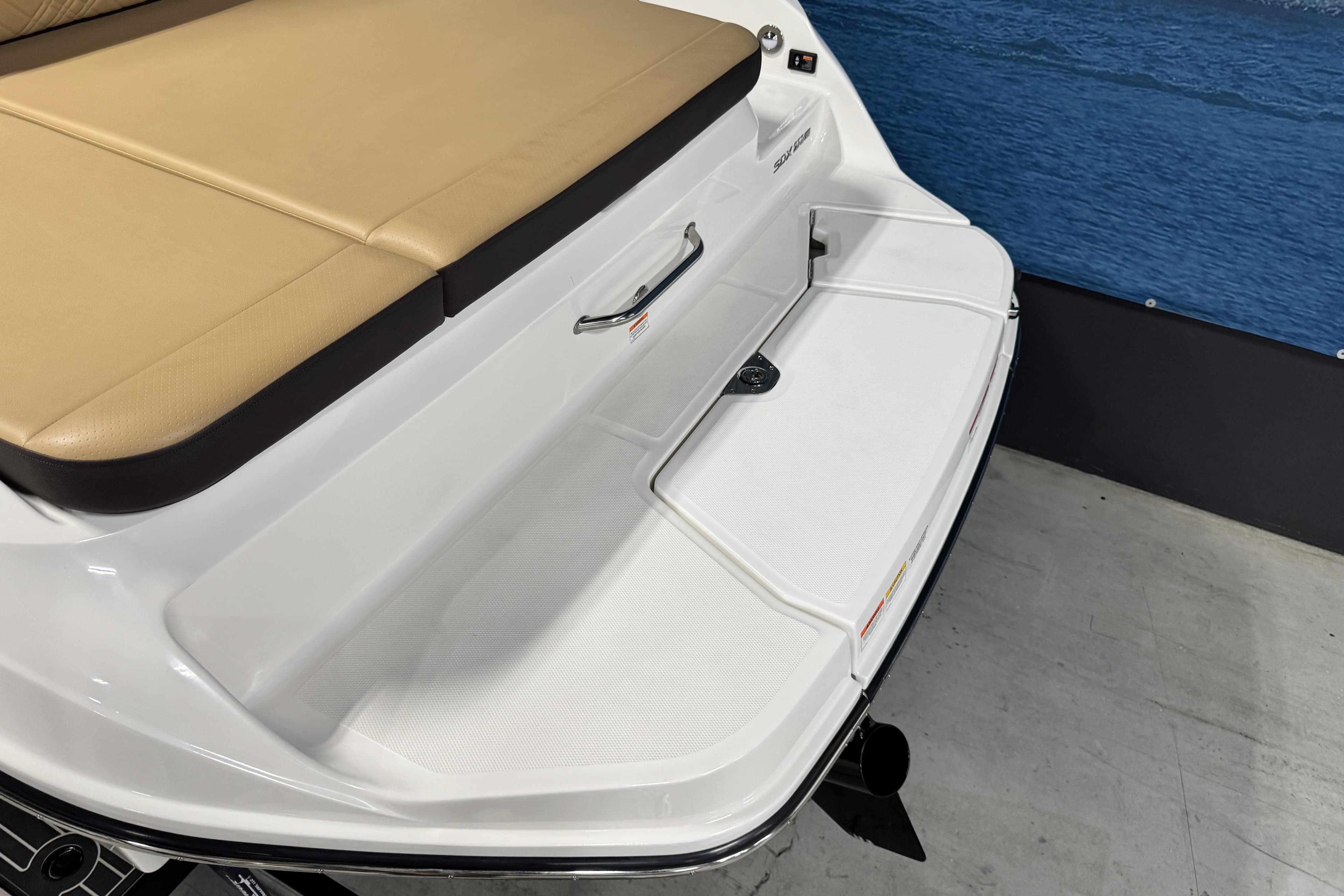 2026 Sea Ray SDX 270 Surf boat with tan seating and white swim platform.