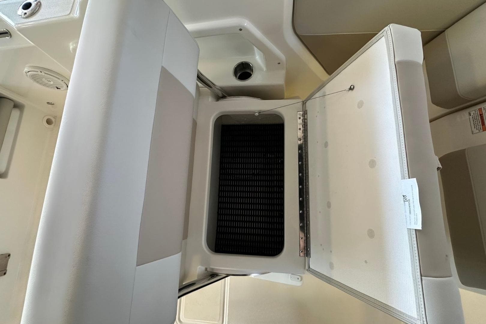 Open storage compartment on 2026 Boston Whaler 210 Vantage boat interior.