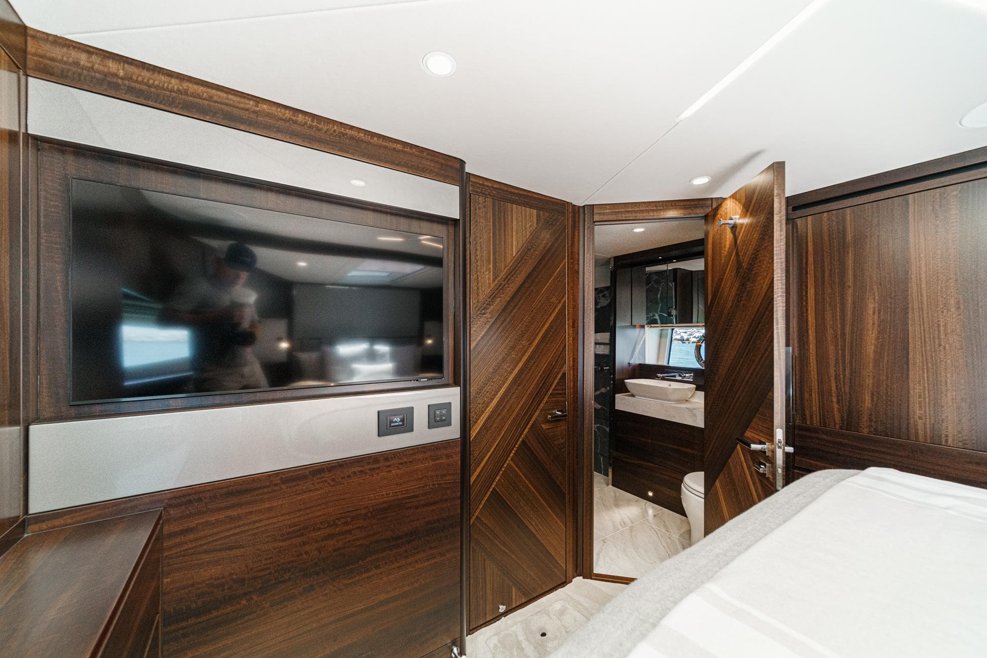 Luxurious interior of 2022 Sunseeker Manhattan 55 yacht with wood paneling and modern amenities.