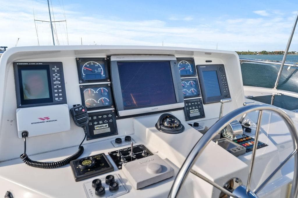 Helm of 2000 West Bay 58 Sonship yacht with navigation instruments and steering wheel.