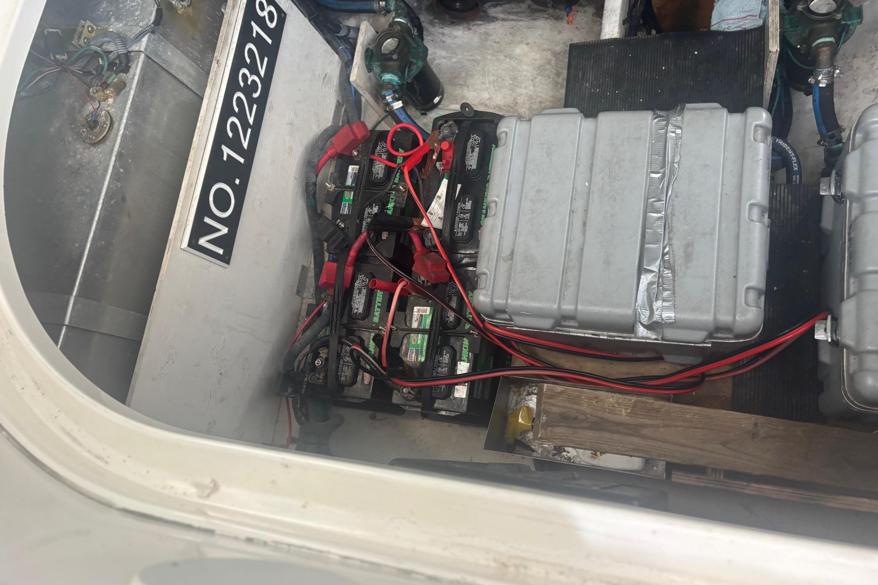 Engine compartment of 2006 Sea Ray 320 Sundancer with batteries and wiring visible.