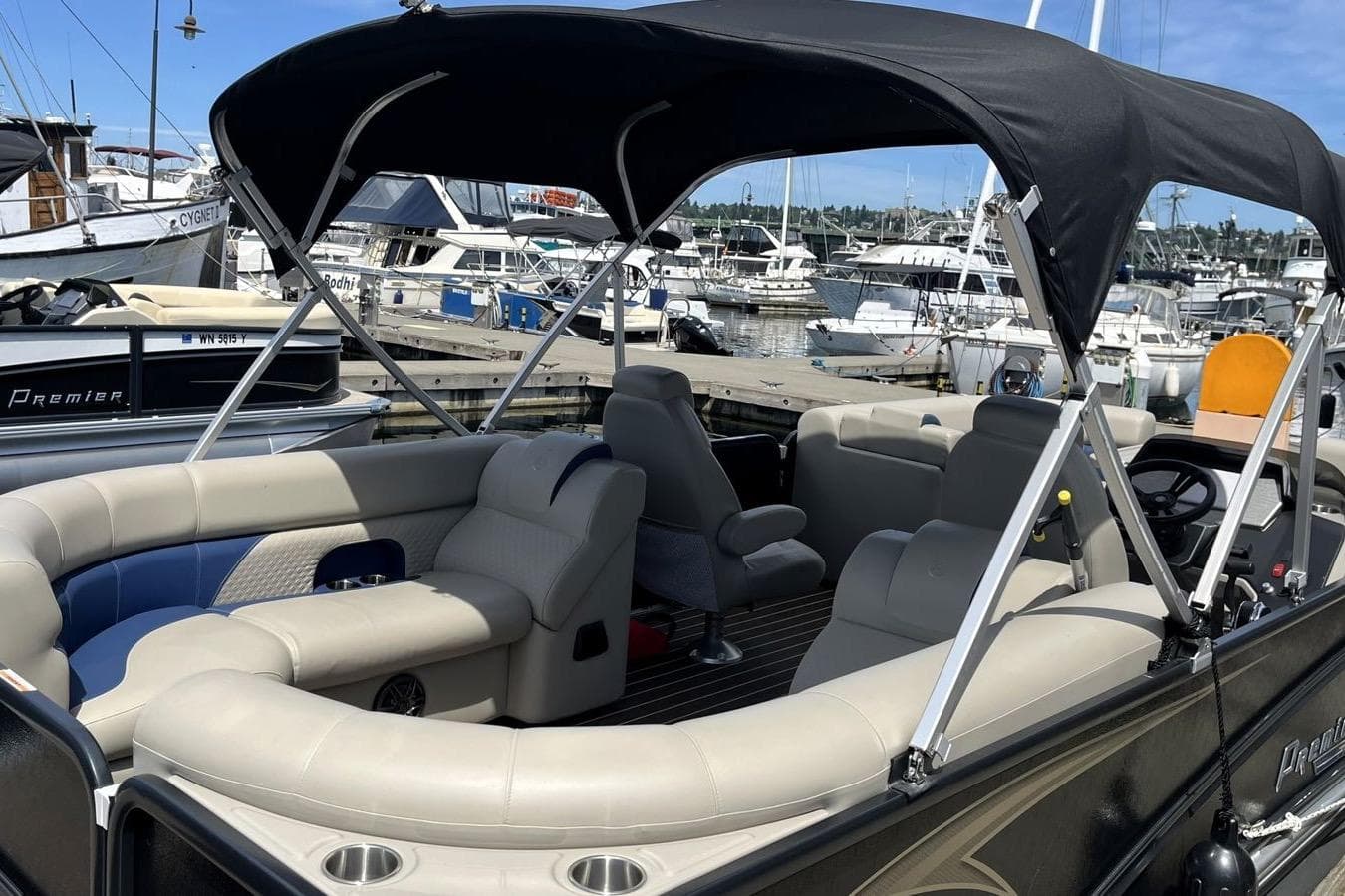 2022 Premier 230 Sunsation RF - CL pontoon boat with canopy, docked at marina.