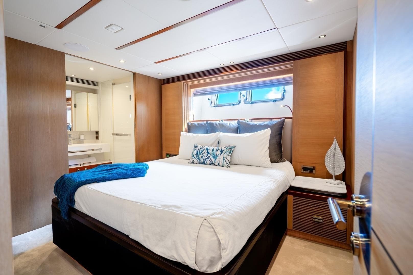 Luxurious bedroom interior on 2020 Horizon FD80 yacht with modern decor and natural light.