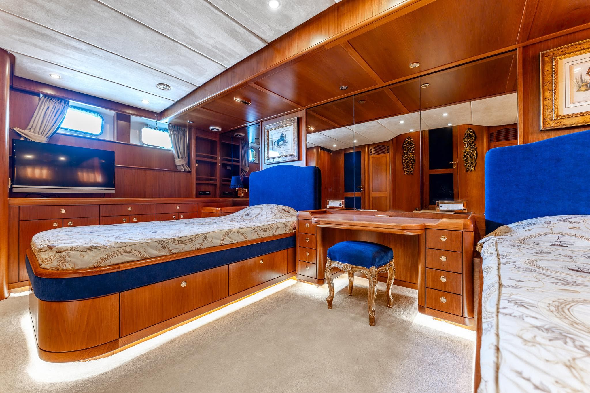 Luxurious 2013 Motor Yacht interior with elegant wood finish and plush blue accents.