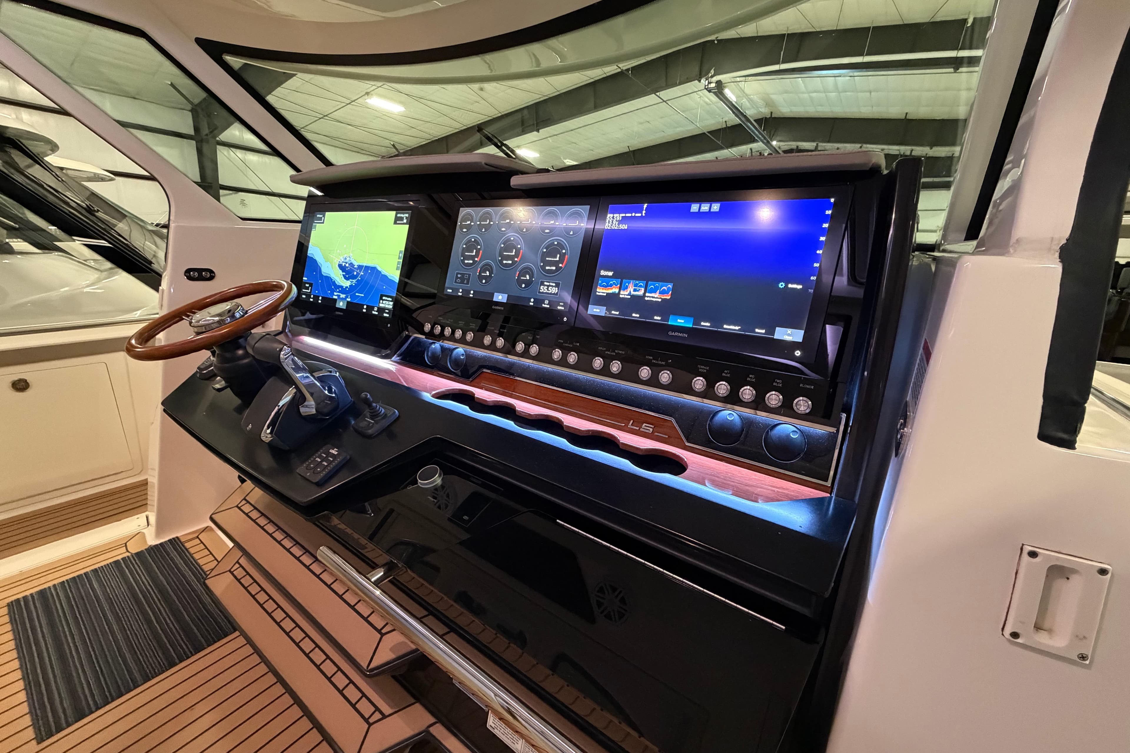 2024 Tiara Yachts 48 LS helm with advanced navigation displays and controls.