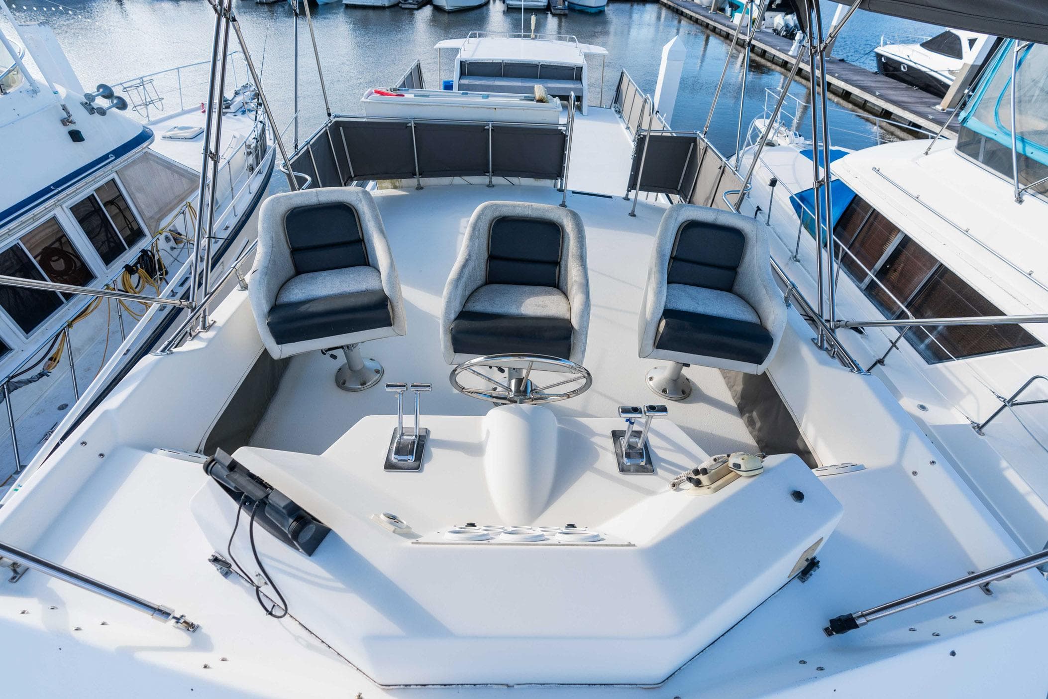 Cockpit of 2001 Harbor Master 520 Coastal yacht with three seats and steering wheel.