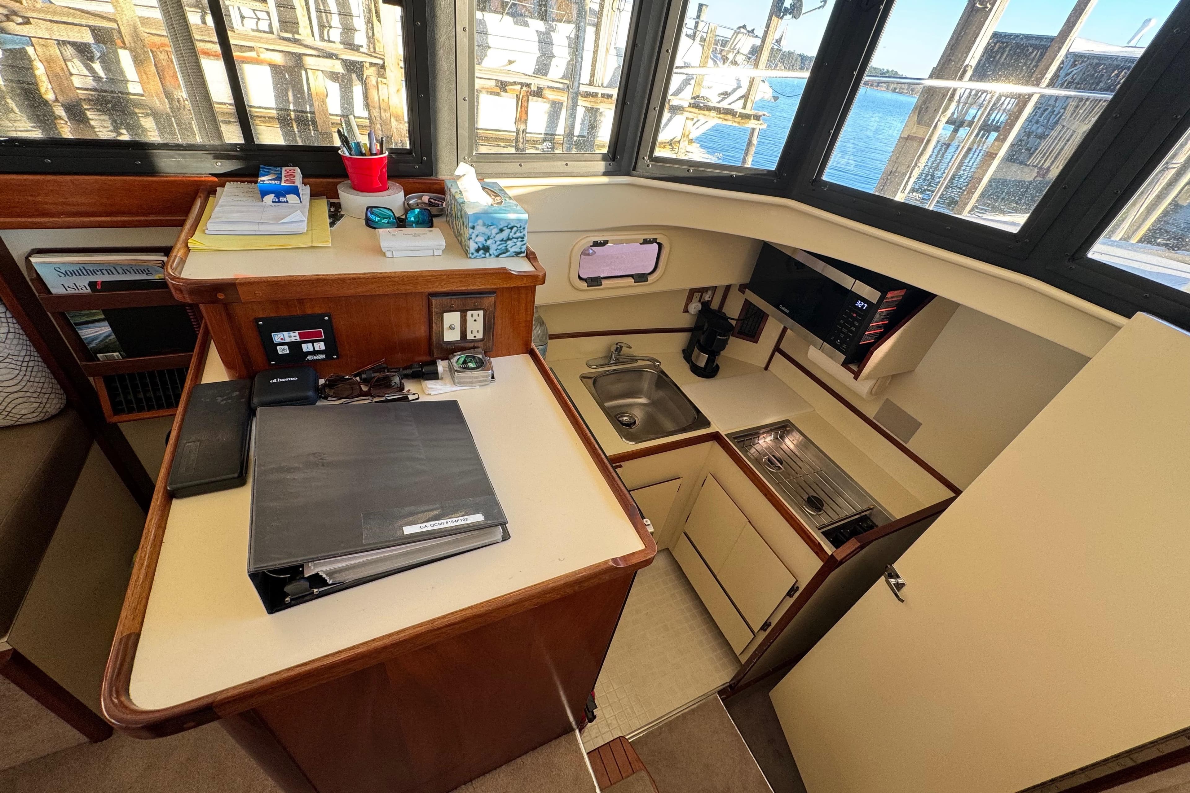 Interior of 2002 Camano Troller boat with compact kitchen and navigation area.