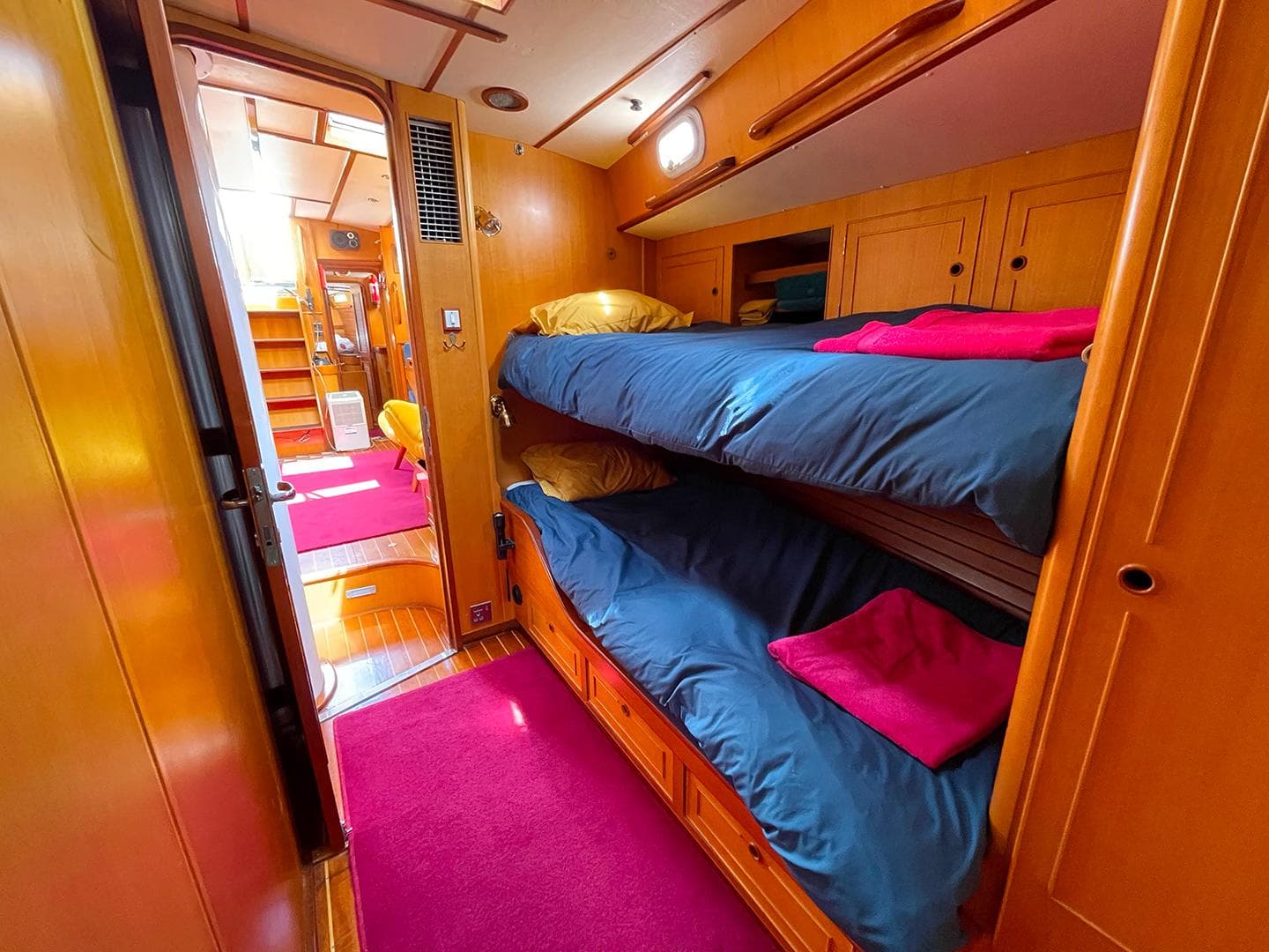 Interior of 1985 Camper & Nicholsons 58 yacht with cozy bunk beds and vibrant decor.